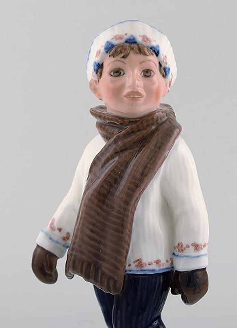 Dahl Jensen porcelain figurine. Boy in winter clothes. Model number 1064. 1st factory quality. 1920/30's.
In very good condition. 
Measures: 20 x 9 cm.
Signed: Kings crown, DJ Copenhagen.