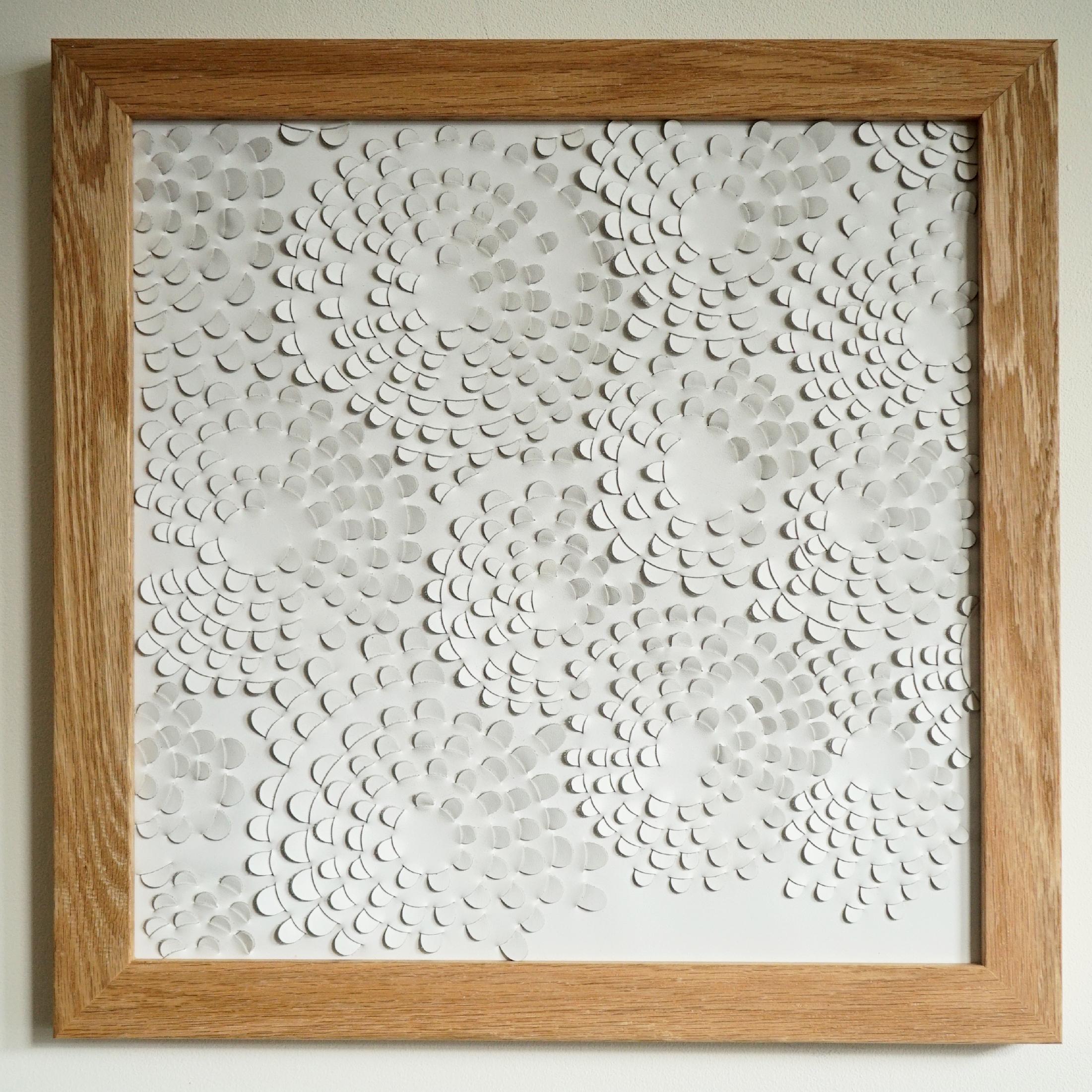 Dahlia:

A piece of 3D sculptural wall art designed and made from two layers of white leather woven together by Louise Heighes.
Measurements are 17 x 17 inches or 43 x 43 cm

Inspired by the mass of small ringed petals that make up the head of the
