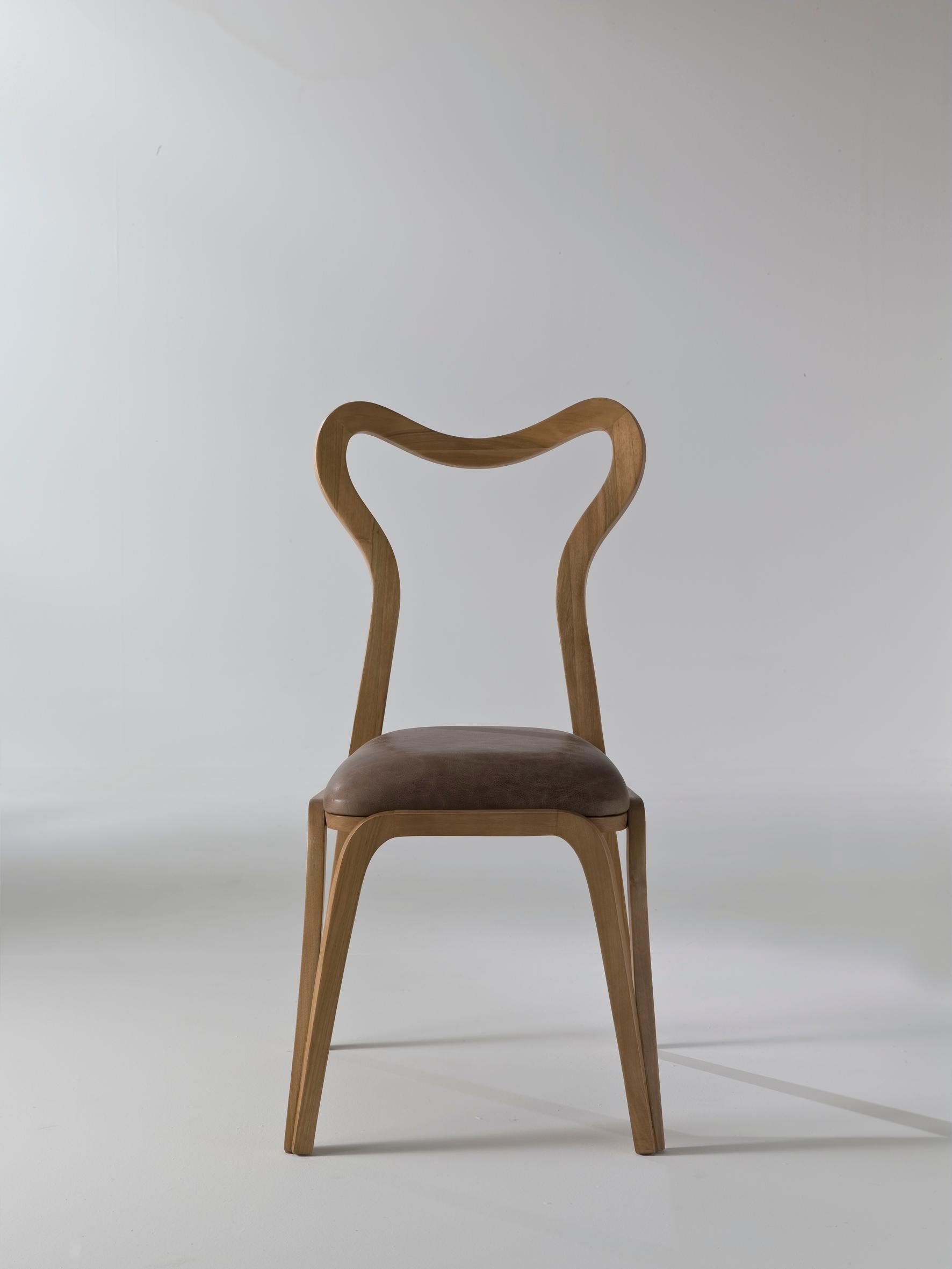 Introducing the Daina Chair—a masterpiece of Italian craftsmanship designed by Nigel Coates, where inspiration from the fallow deer's flexibility and the grace of the female body converges to create a chair that exudes elegance and