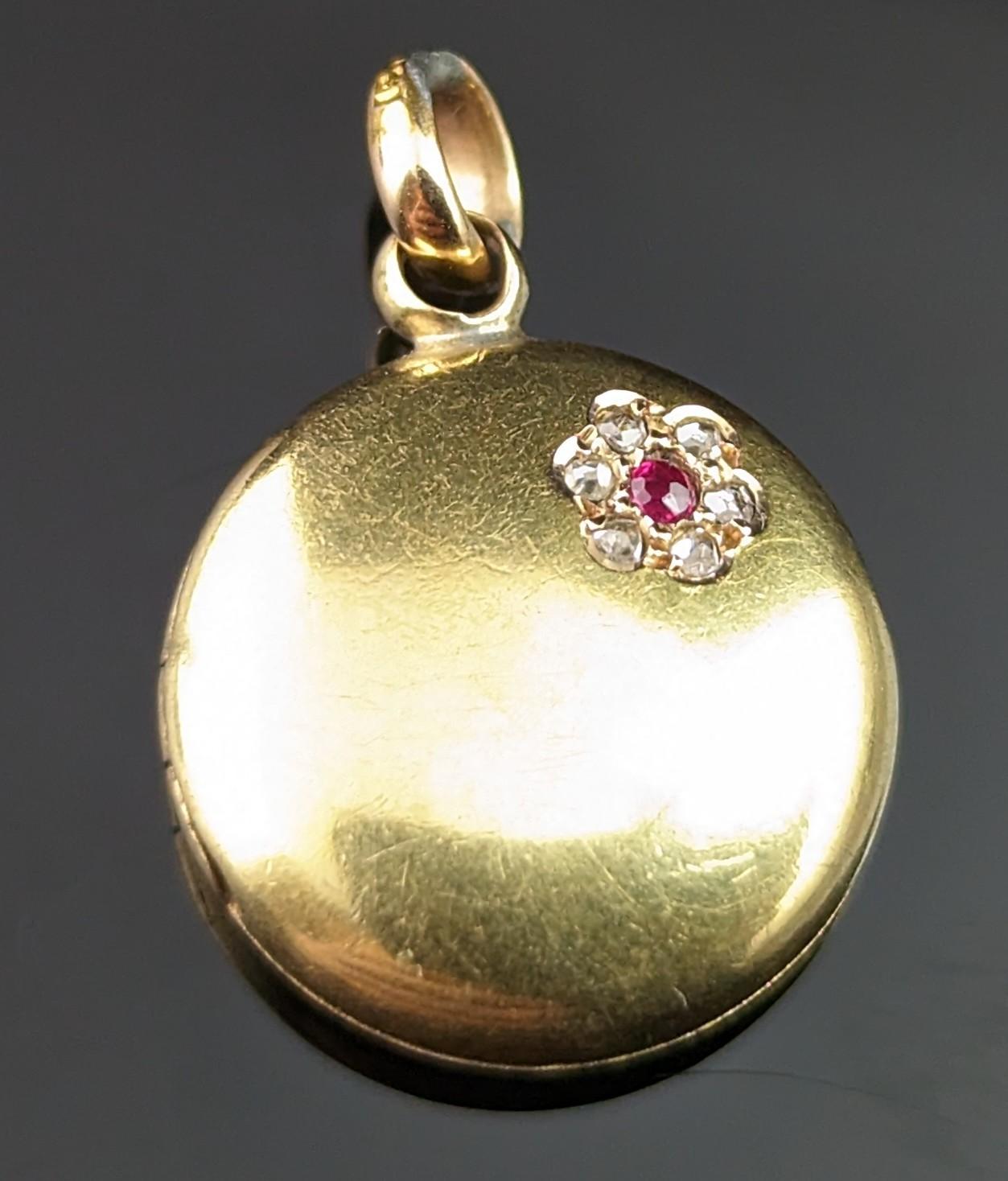 Ohh this dainty little antique Diamond and Ruby locket is just so sweet and adorable.

Teeny sized, it is a circular shaped locket in rich antique 15kt yellow gold, the gold has a slightly brushed finish giving it a warm aged glow.

To the front