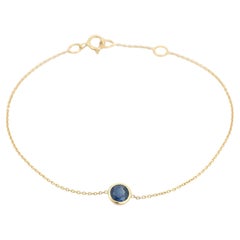 Bracciale a catena con zaffiri blu rotondi incastonati in oro giallo 14 carati
