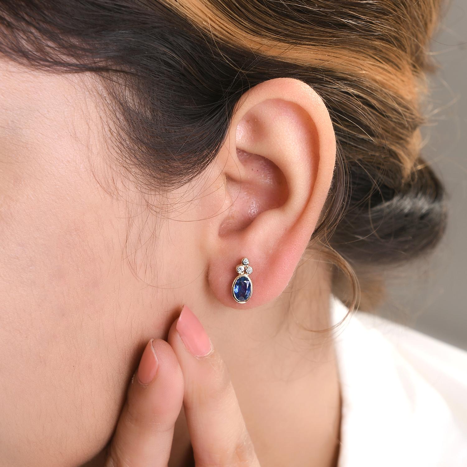 Dainty Blue Sapphire Diamond Stud Earrings in 14K Gold to make a statement with your look. You shall need stud earrings to make a statement with your look. These earrings create a sparkling, luxurious look featuring oval cut blue sapphire and round