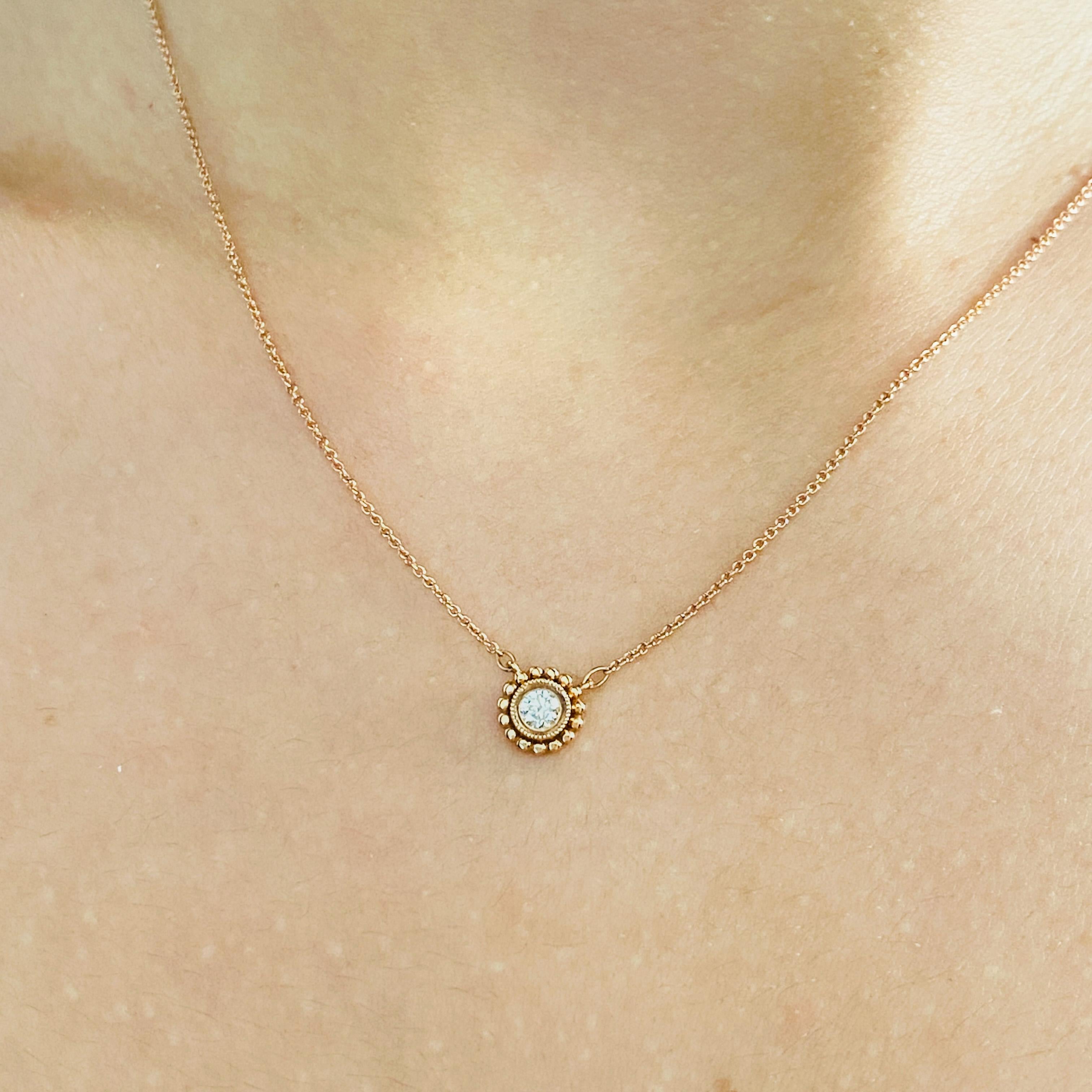 Add a dainty diamond daisy in rose gold to the neck of a loved one. This beautiful petite pendant has a sparklingly bright diamond made to flatter your favorite person in rose gold! The flower-like frame is accented by a fine milgrain texture along