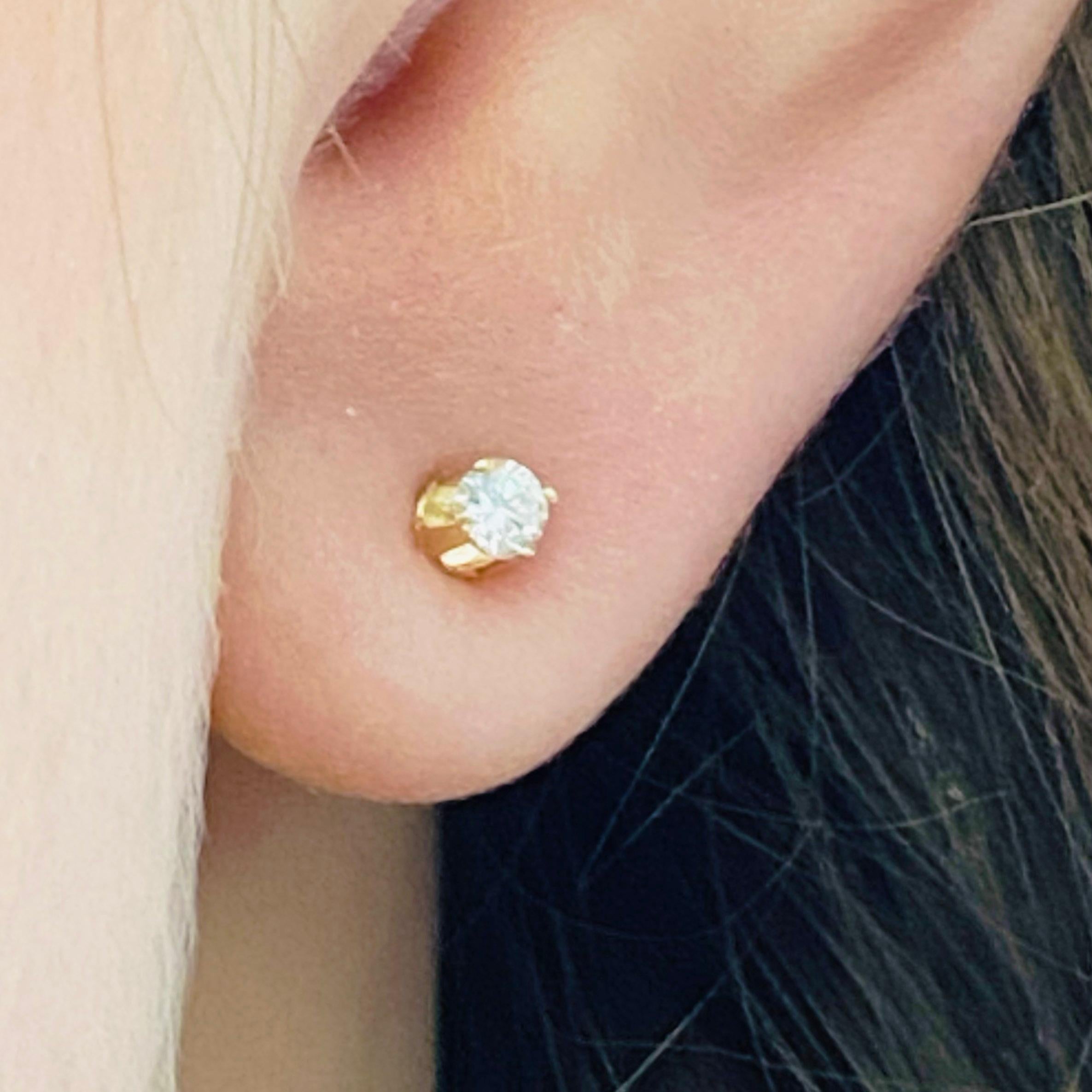 These stunning 14k yellow gold round diamond stud earrings provide a look that is both trendy and classic. These diamond earrings are a great staple to add to your collection, and can be worn with both casual and formal wear.  These earrings would