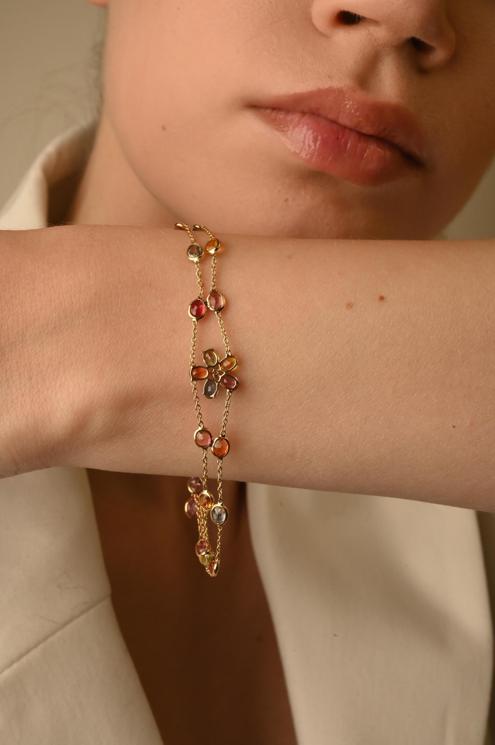 Dainty Flower Multi Sapphire Double Chain Bracelet in 18K Gold with Diamonds . A gold gemstone bracelet is the ultimate statement piece for every stylish woman.
Adorn your wrist with this beautiful oval cut multi sapphire chain bracelet in 18 Karat