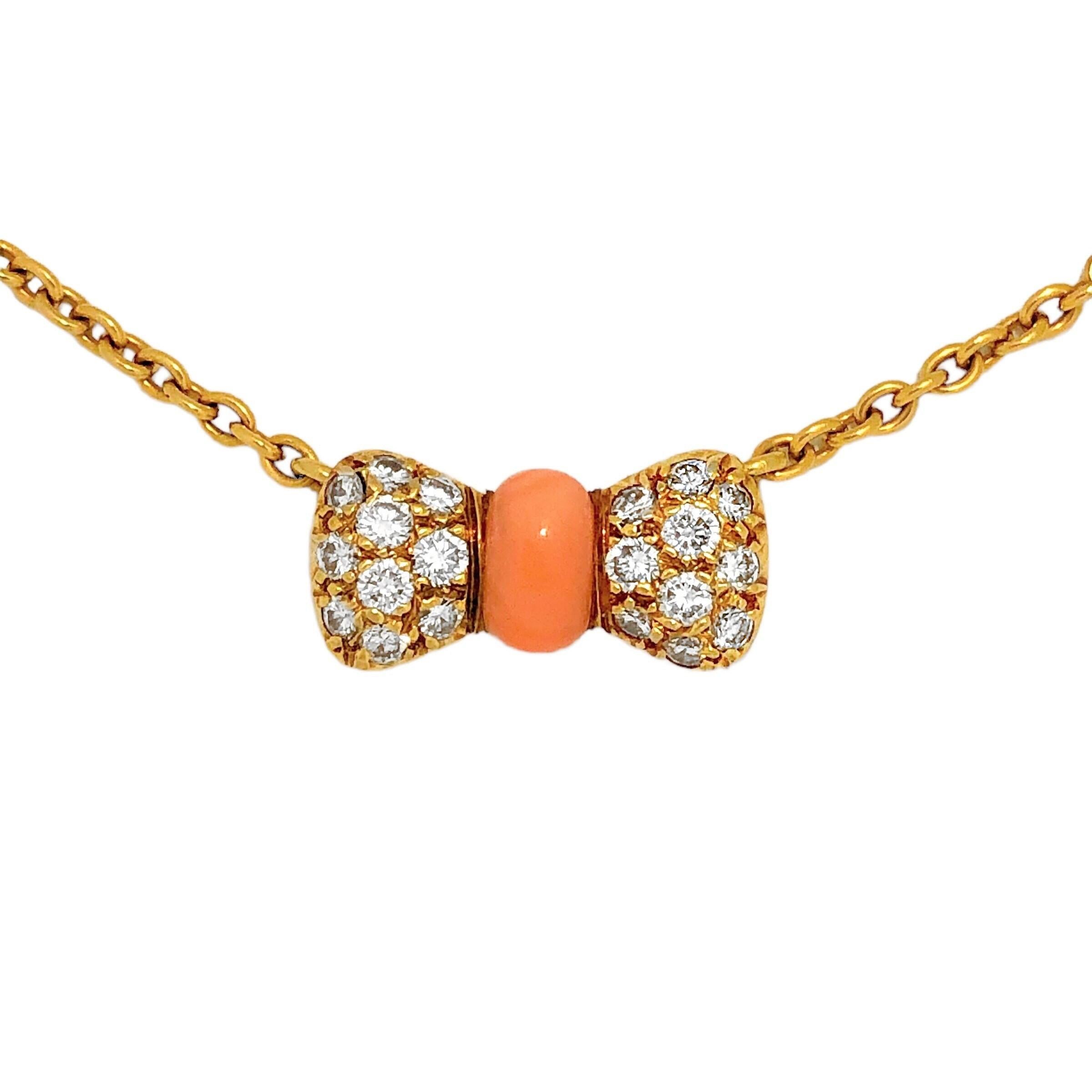 This lovely and very feminine VCA necklace is crafted from 18K yellow gold, fine quality brilliant cut diamonds and bright Angel Skin coral. The bow at the center measures approximately 9/16 inches by 5/16 inches and is suspended from a VCA light