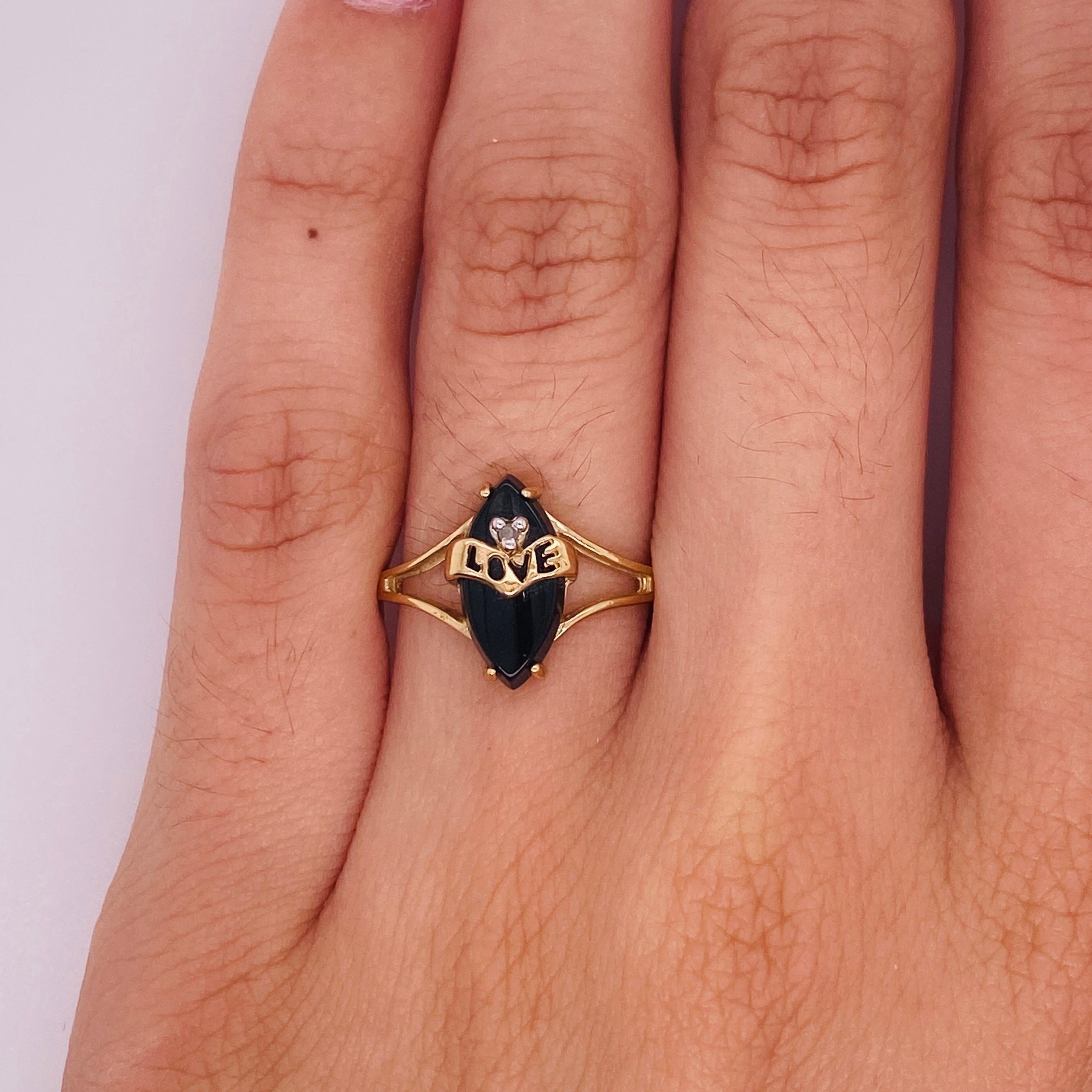 Spoil someone special with this dainty black onyx love ring. Love, joy, and celebration are represented in the marquise shape of the 1.13 carat onyx tablet. The strong black onyx tablet is the perfect backdrop for the pierced yellow gold ribbon that