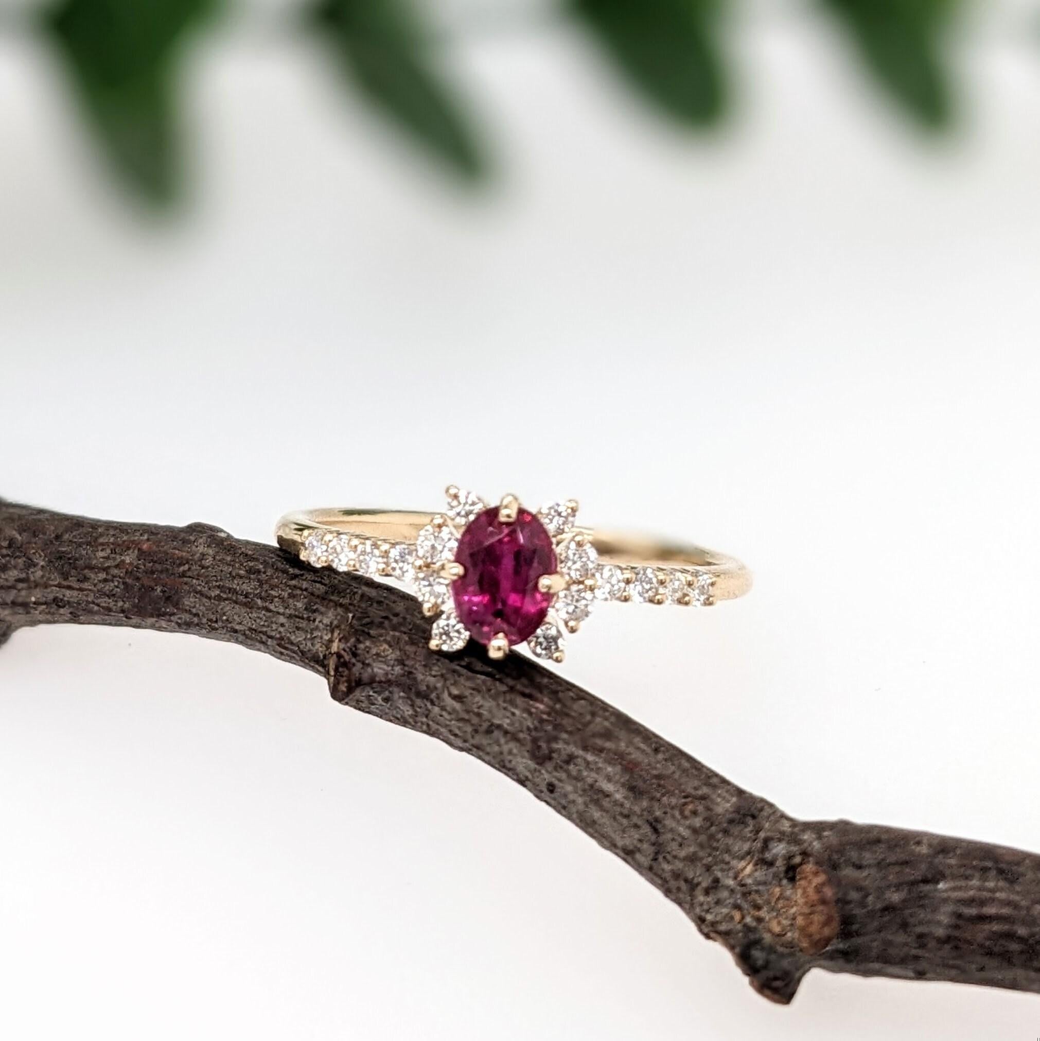 This ring features a gorgeous pigeon blood red heated ruby from Madagascar, held in place by a compass pronged setting in 14k solid yellow gold. The natural earth mined diamond accents are meaningfully place to created a unique halo shape that