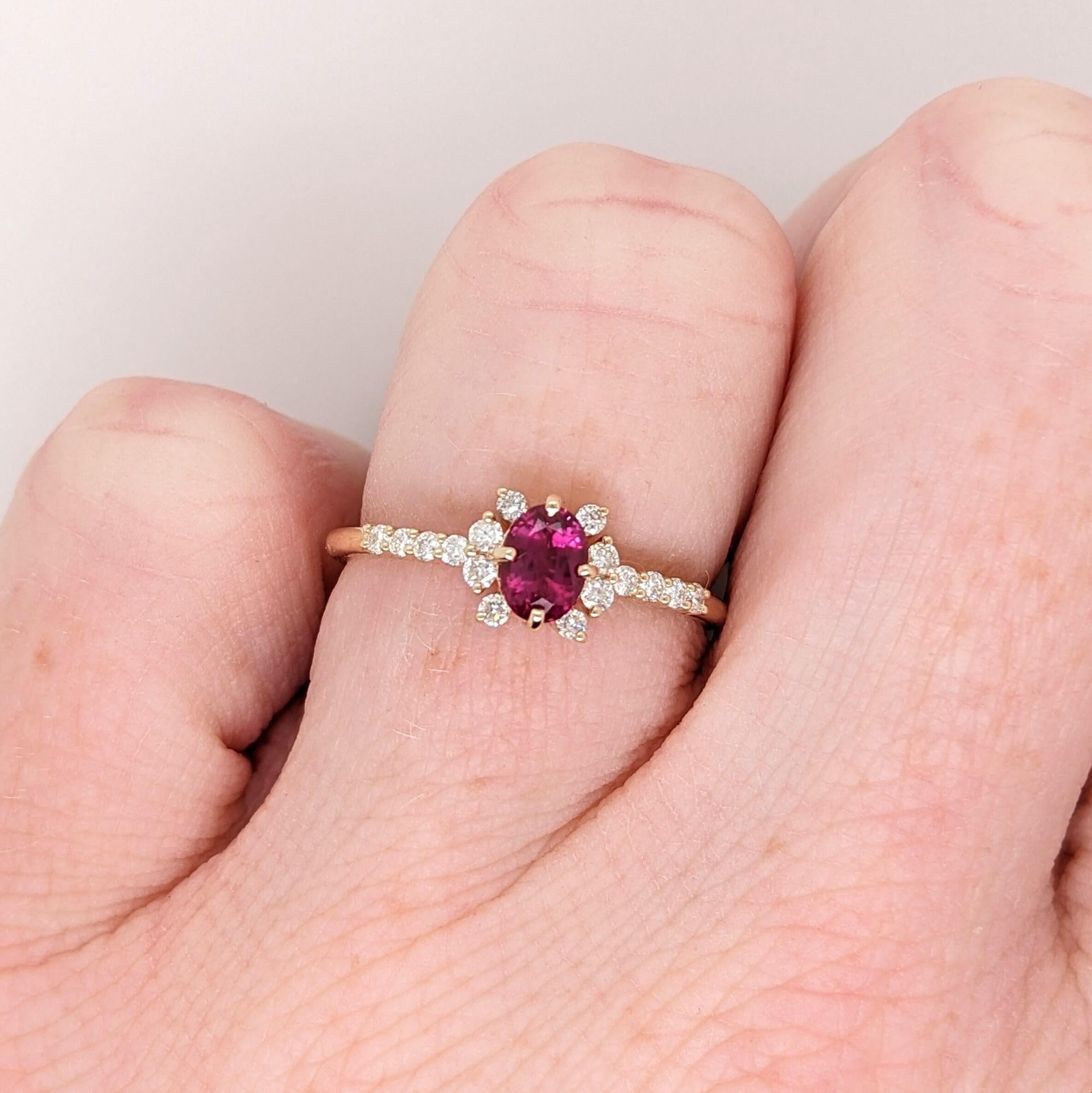 This ring features a gorgeous pigeon blood red heated ruby from Madagascar, held in place by a compass pronged setting in 14k solid yellow gold. The natural earth mined diamond accents are meaningfully place to created a unique halo shape that