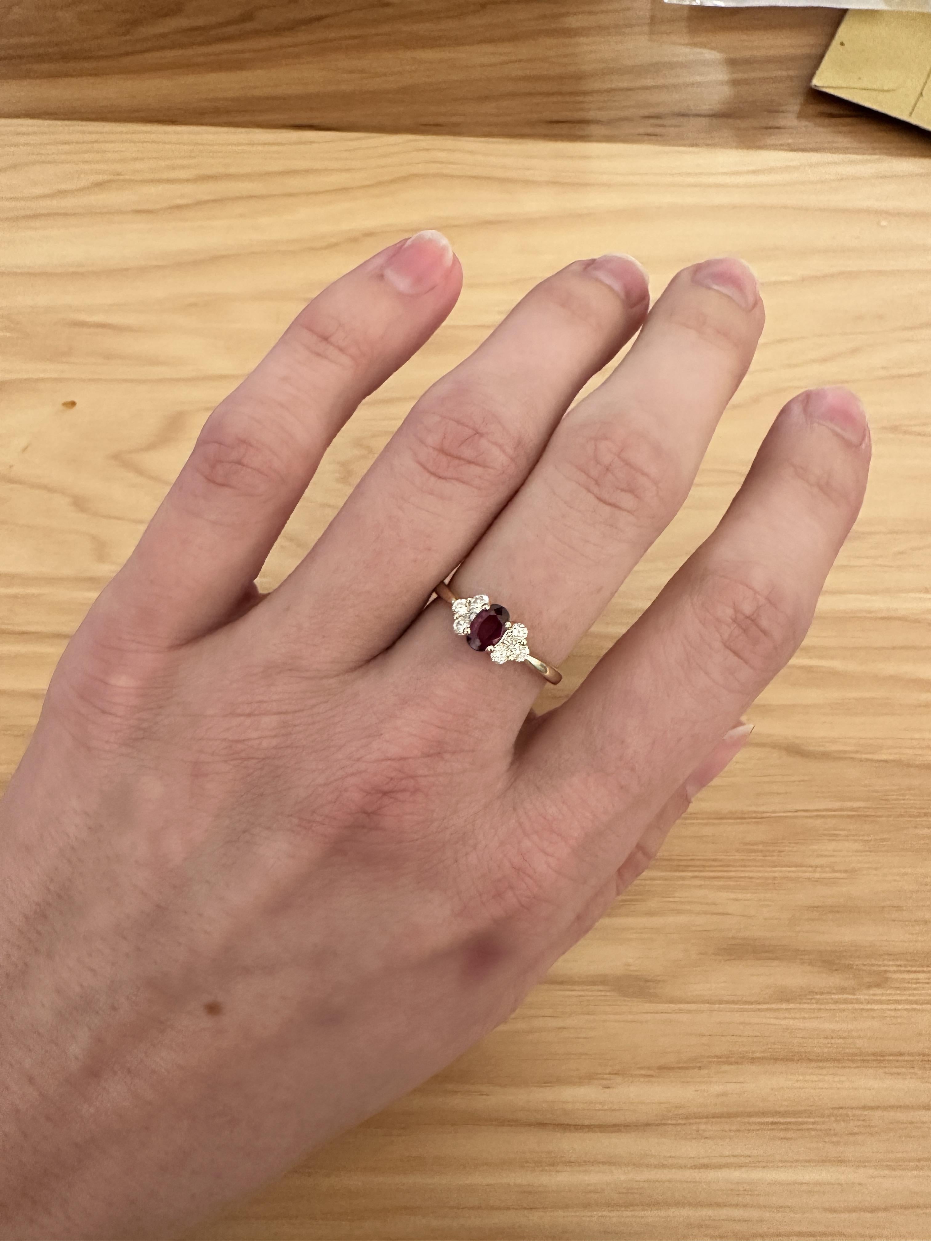 Elevate your look with a minimalist ruby ring. Crafted with a stunning oval natural earth mine ruby surrounded by natural diamond accents. Made with solid 14K yellow gold, this delicate ring is perfect for adding a touch of sophistication to any