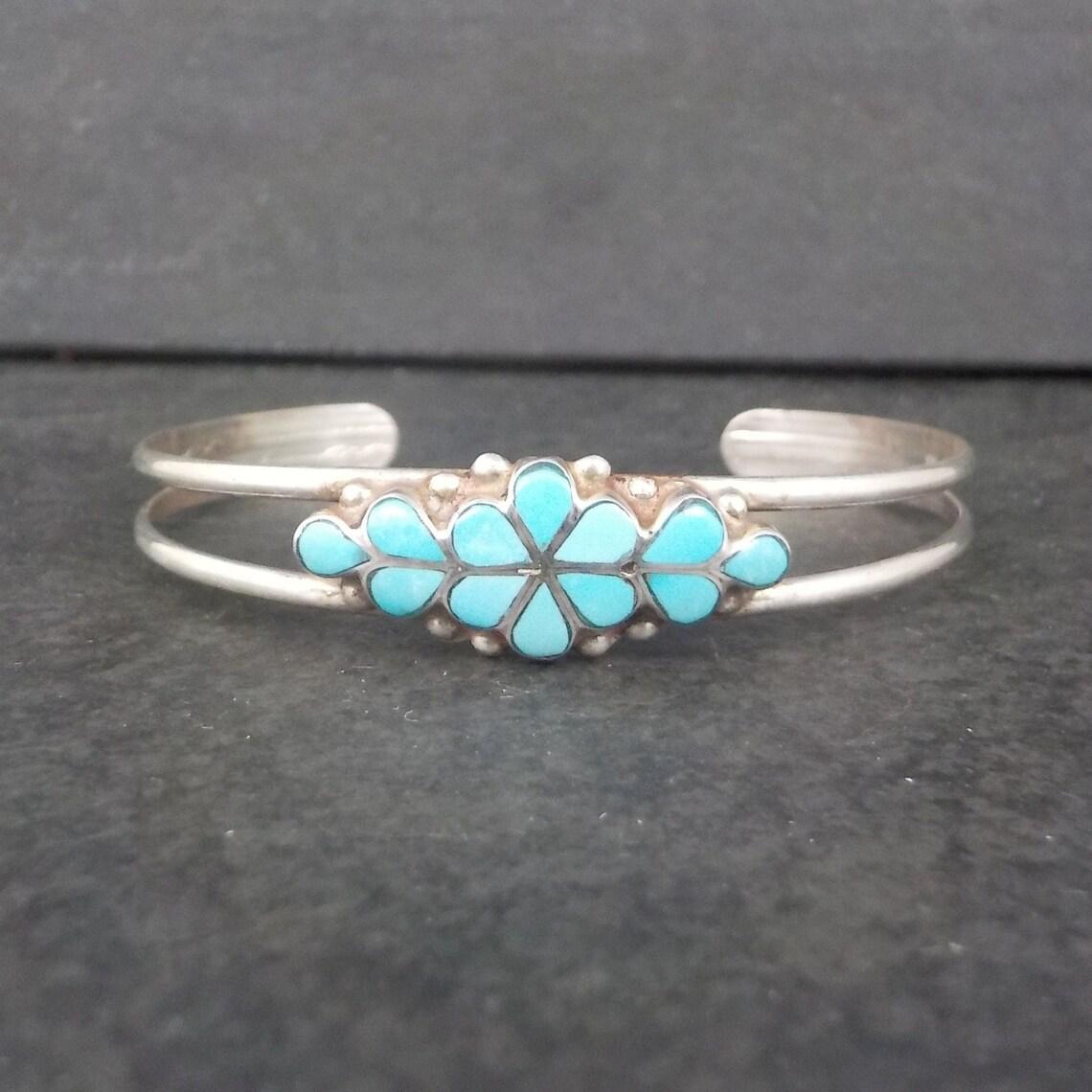 This beautiful vintage Southwestern cuff bracelet is sterling silver with natural turquoise inlay.

The face of this bracelet measures 7/16 of an inch wide.
It has an inner circumference of 6 inches including the 1 inch gap.
Weight: 7.6