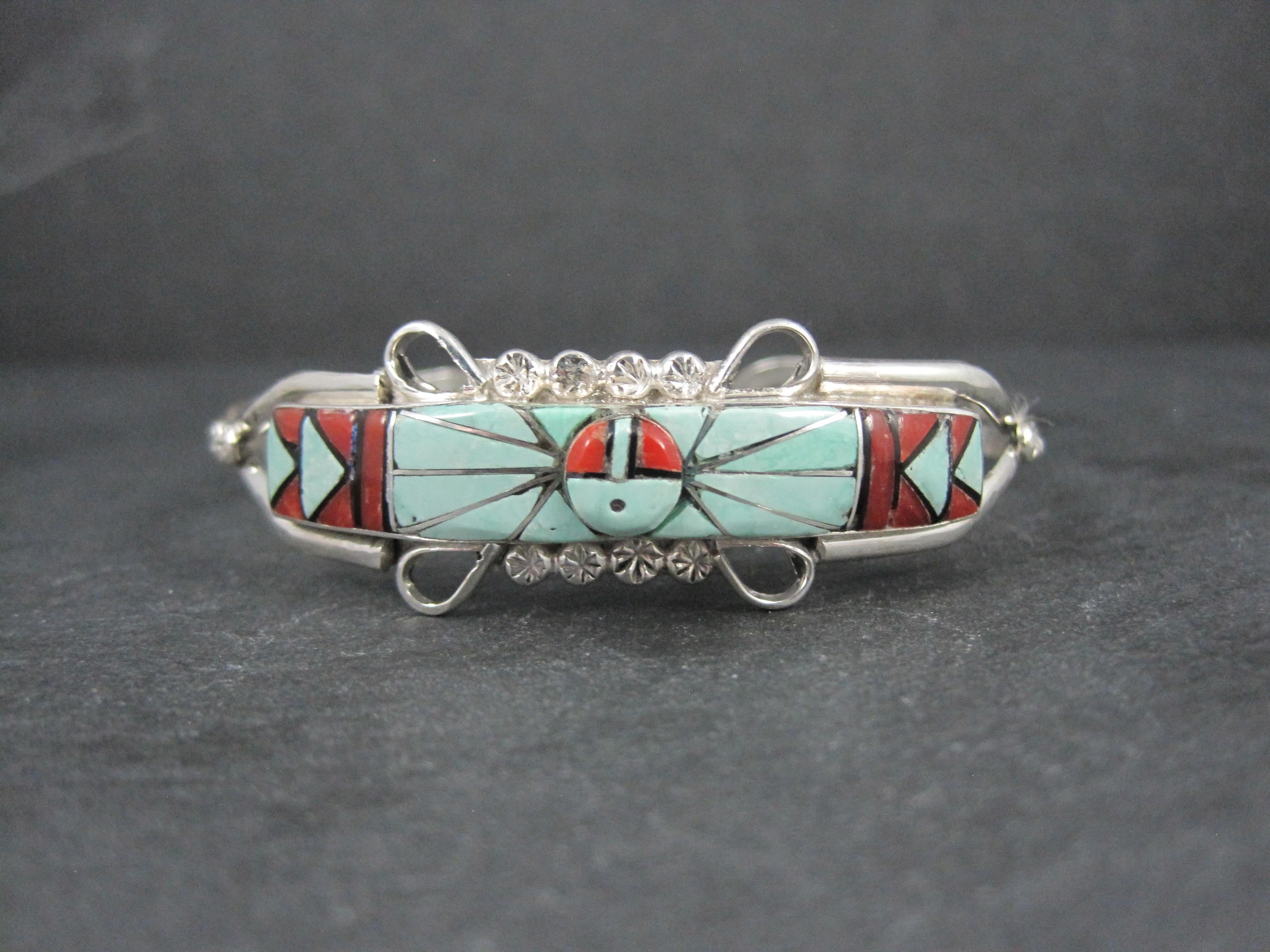 This gorgeous cuff bracelet is sterling silver with turquoise, coral and jet inlay.
It measures 3/4 of an inch at its widest point.
It has an inner circumference of 6 1/2 inches, including the gap.
Made by Zuni silversmith Ola Eriacho.
New Old Stock
