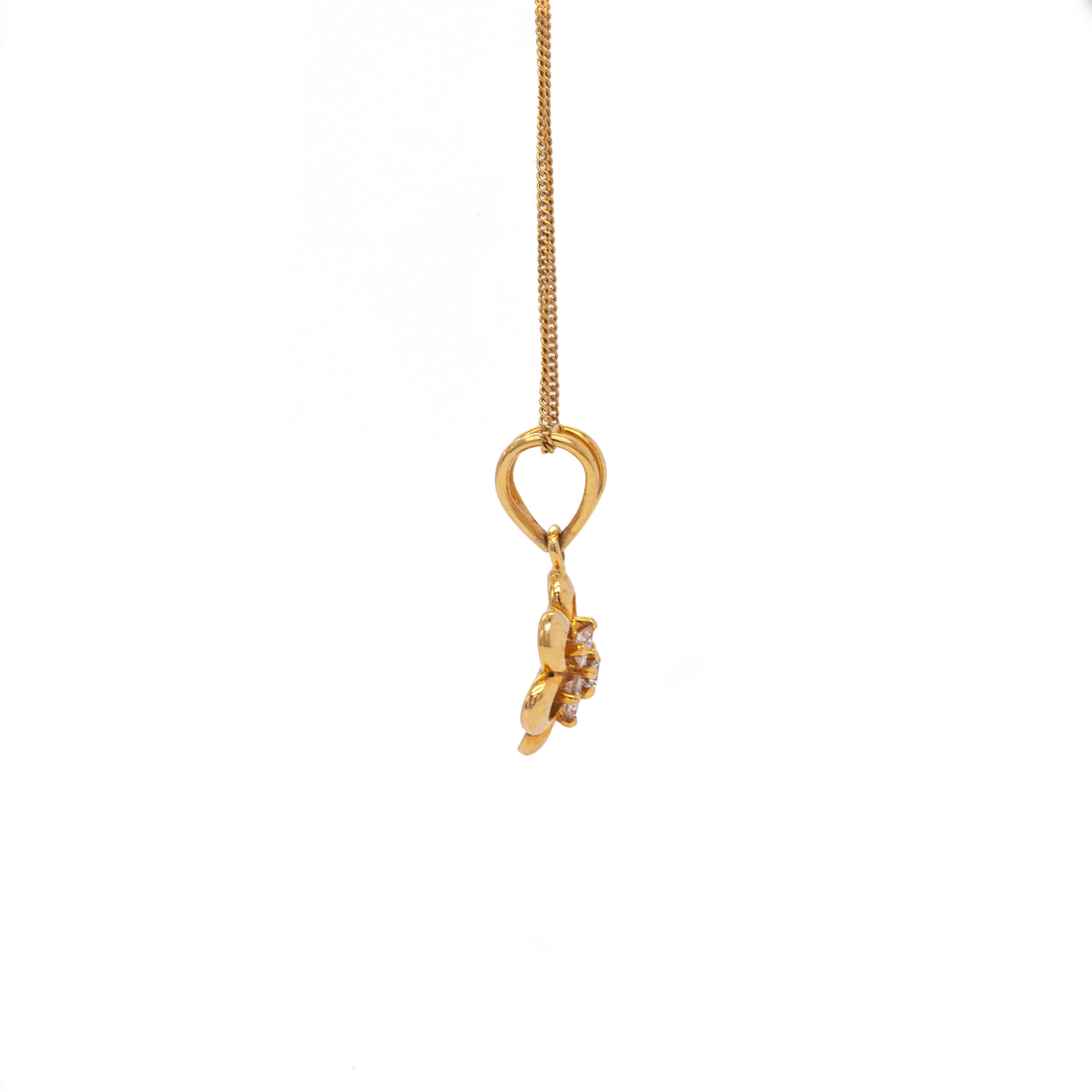 This lovely pendant portrays a delicate daisy flower designed with slightly curved openwork petals, finely crafted in 18 carat yellow gold.

A wonderful cluster of 7 fine quality round brilliant cut diamonds, weighing approximately 0.30ct combined,