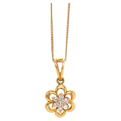 Pendentif et chaîne fleur en or jaune 18 carats avec grappe de diamants en forme de marguerite