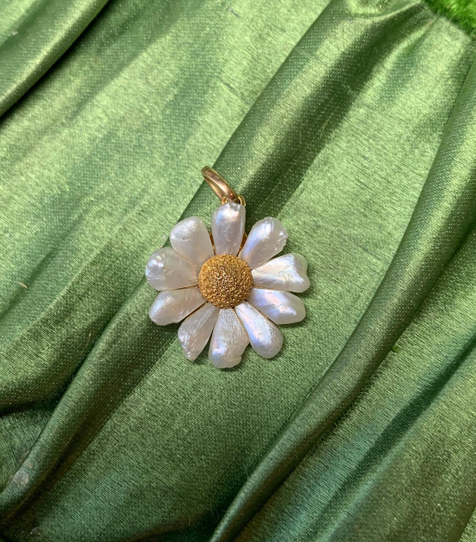 A gorgeous Daisy Flower pendant with stunning pearl petals and a lovely brushed 14 Karat Yellow Gold center.  Just a charming delicate romantic Daisy pendant charm to hang from your favorite necklace or bracelet.

The pendant is 17mm long without