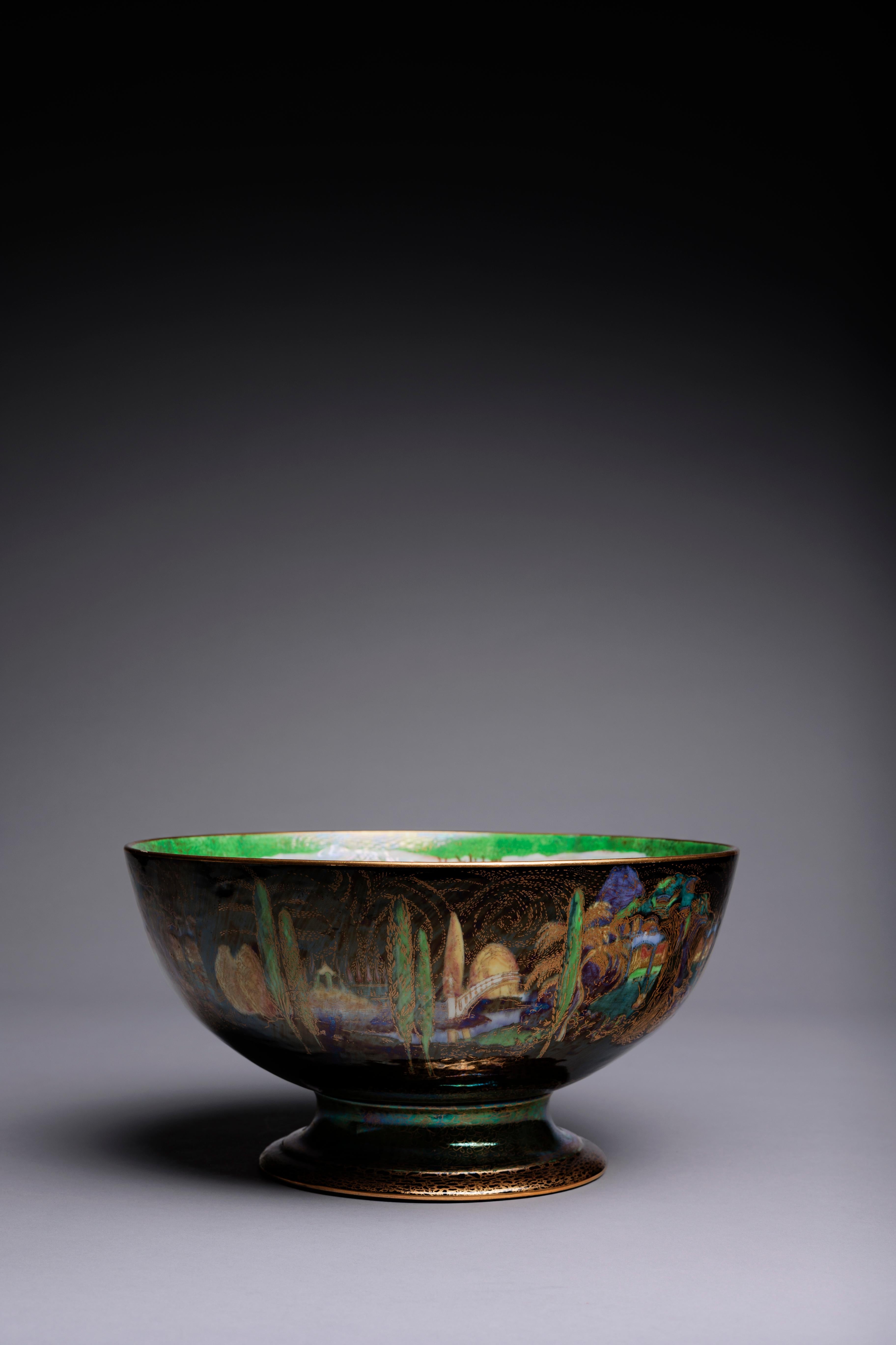 A Daisy Makeig-Jones Fairyland Lustre bowl made circa 1925, showing the Poplar Trees pattern on the exterior and the Woodland Bridge pattern on the interior, with the central interior medallion showing the Mermaid motif.

The interior Woodland
