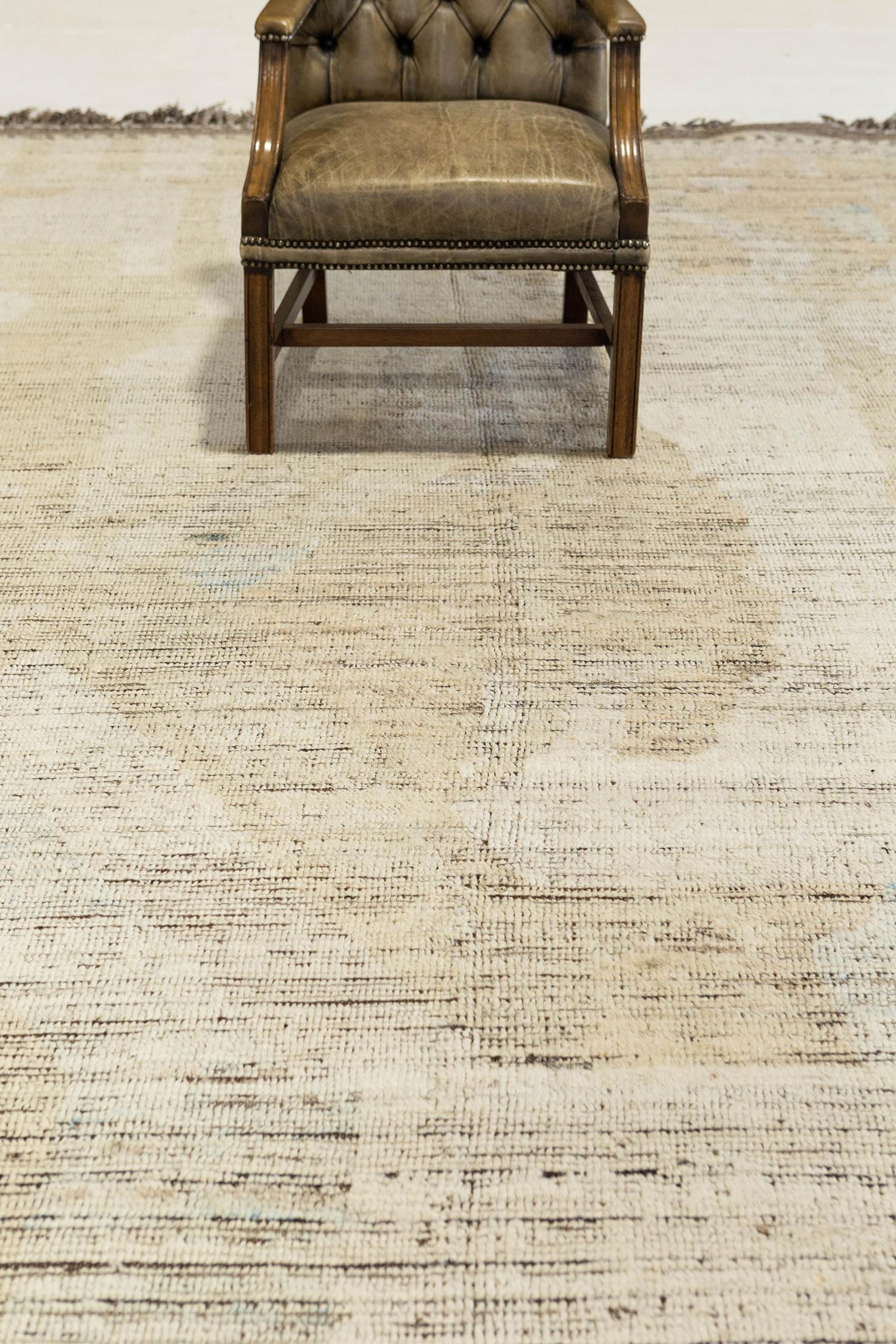 'Dakhla' is a beautifully textured rug with irregular motifs inspired from the Atlas Mountains of Morocco. Neutral colored shag atop a brown pile weave work cohesively to make for a great contemporary interpretation for the modern design world.