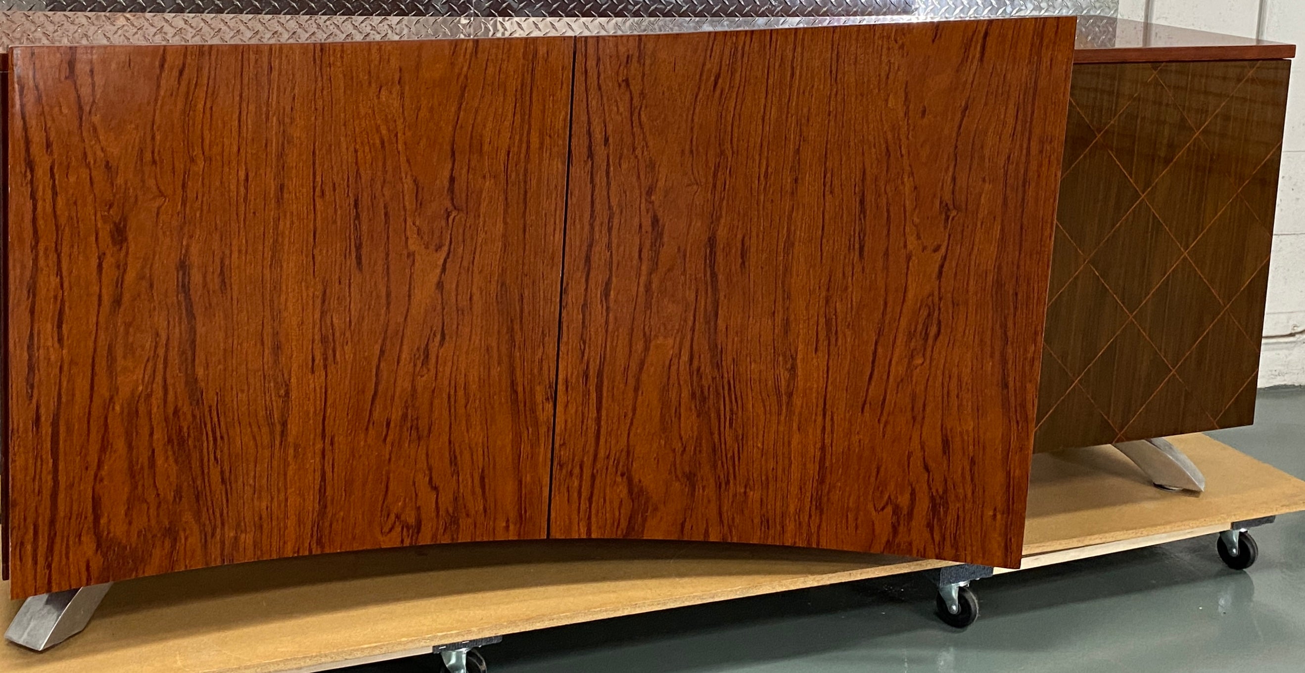 This stunning Dakota Jackson credenza or mid-century modern buffet made of rosewood exemplifies the best of American  modern design with hints of Danish style. Crafted in Italy by skilled artisans, it boasts a generous amount of storage with three
