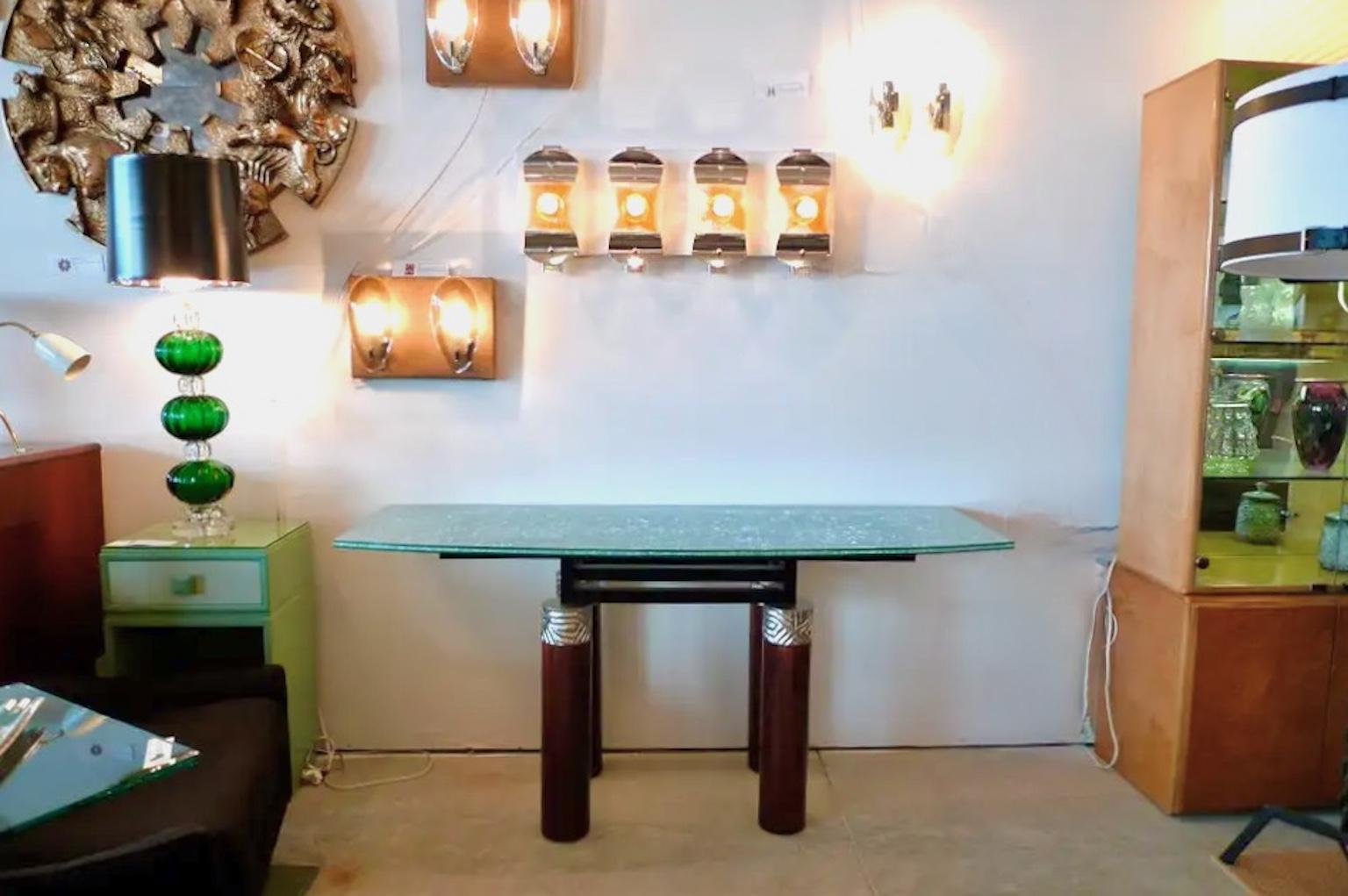***SUMMER SALE***

Cuba console table by Dakota Jackson, circa 1989.
Four bronze cap mounts on polished mahogany cylindrical legs.
Ebonized ashwood super structure.
Curved front top of laminated crackled safety glass.