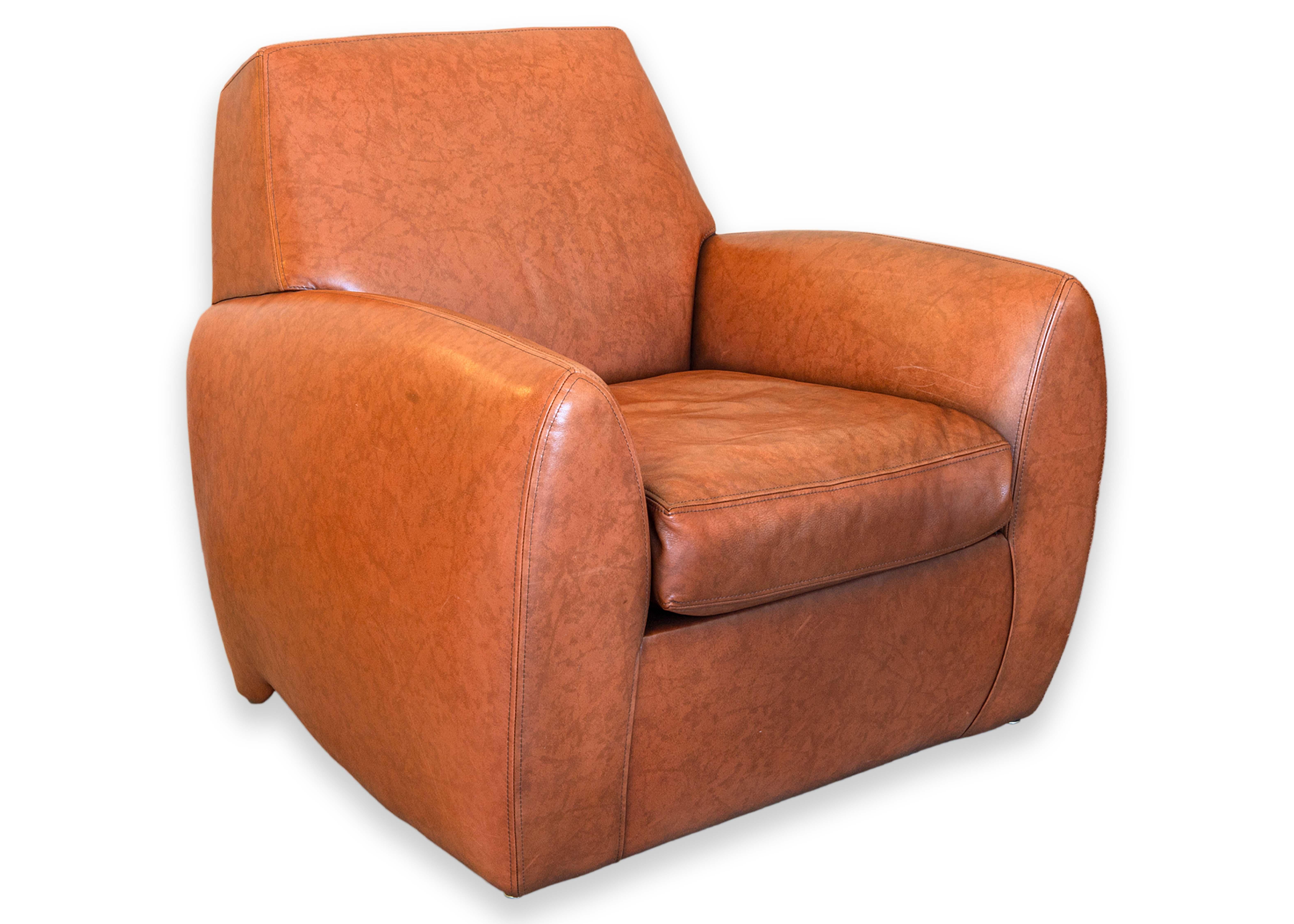 A Dakota Jackson Ke-Zu accent lounge chair and ottoman. This gorgeous 1980s lounge set features a plush chair and matching ottoman. Each of these piece are upholstered in a beautiful calfskin leather with a brown/orange coloration. This leather has
