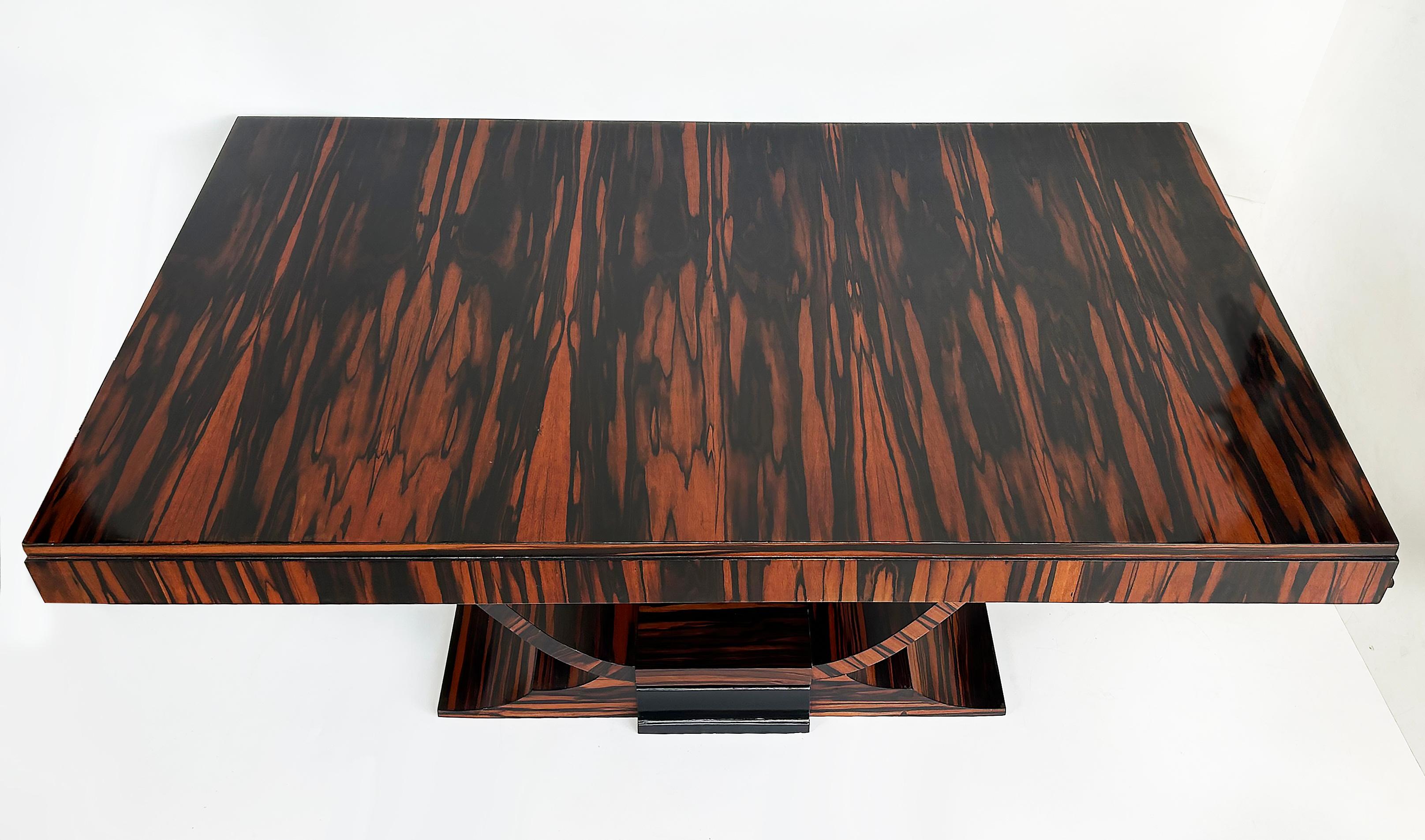 Dakota Jackson Style Macassar Ebony Dining Table, Art Deco Style, Newly Refinished

Offered for sale is a Dakota Jackson style Art Deco style dining room table.  This table is newly refinished.  There are two slide supports that open and extend to