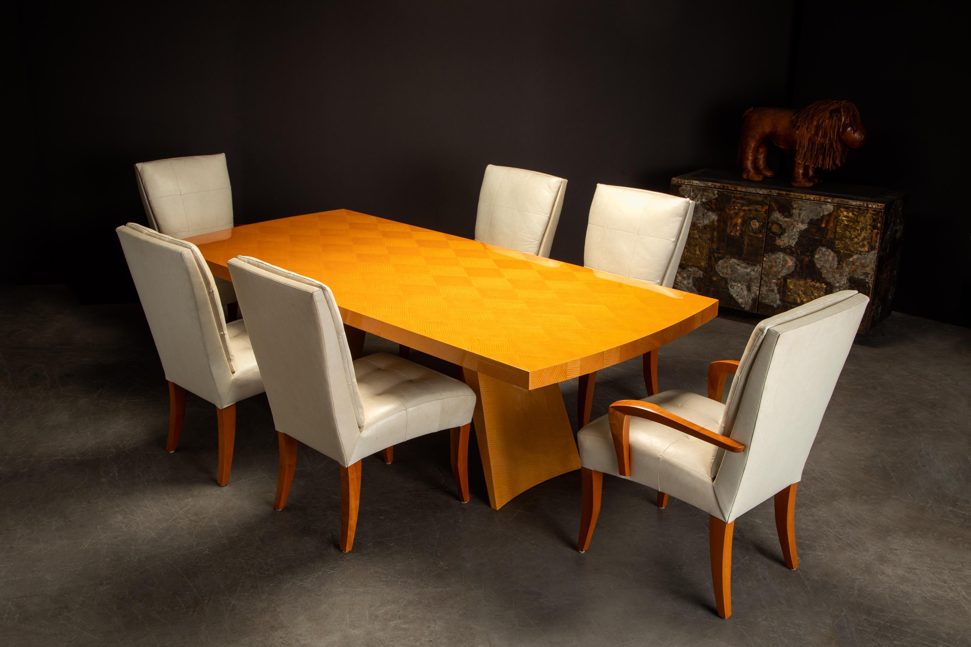 This incredible exotic wood and leather dining set, which would also make an amazing conference table and chair set, by luxury design superstar Dakota Jackson includes a 'Wonder' dining table and six 'Puff' dining chairs. Signed under the dining