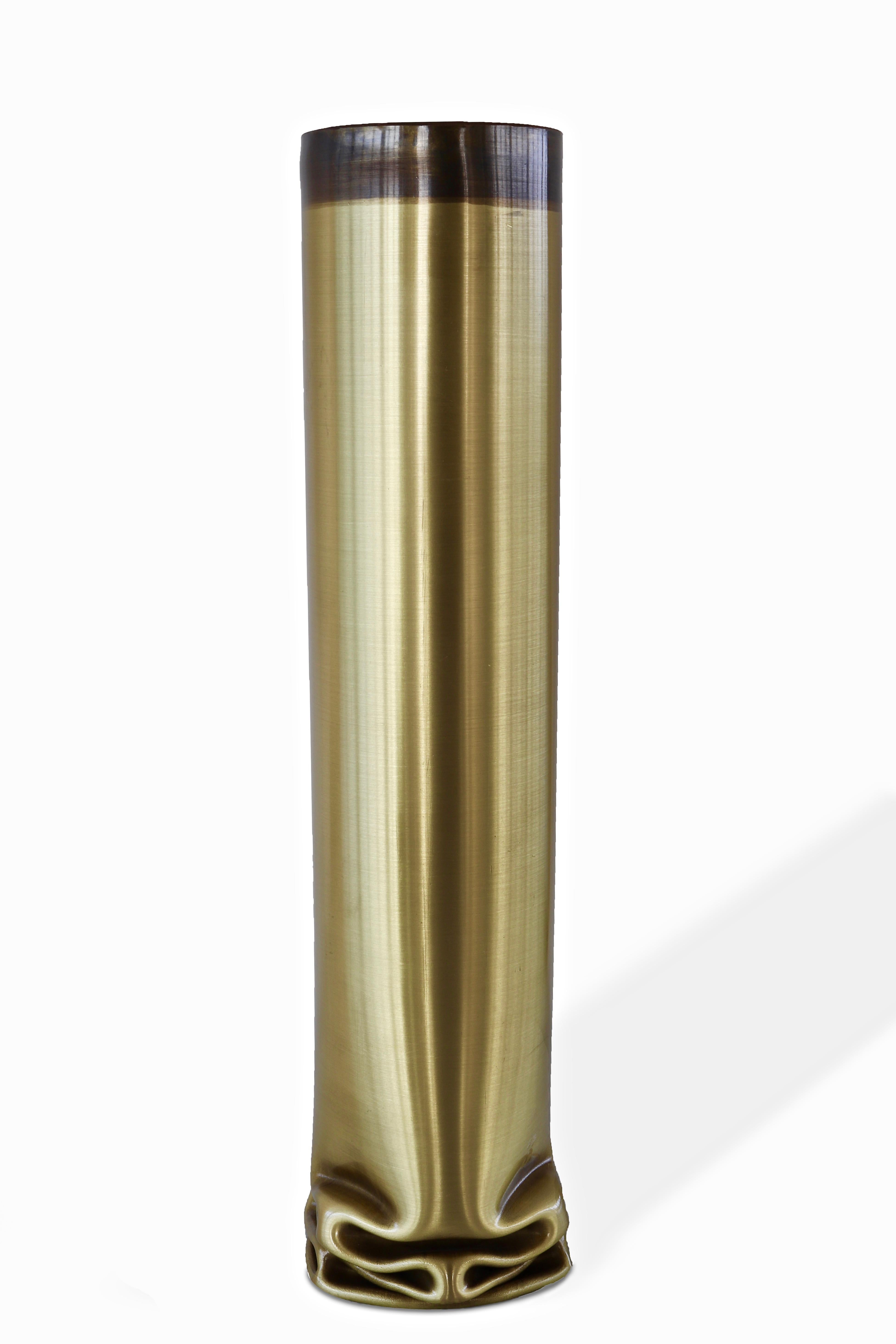 Cylindrical modern vase in brass molded with fire to obtain the effect of a piece that is melting . The surface can be natural satin brass or bronze patina brass .Part of the hot brass/copper collection . 
The hot brass vase can be exposed together