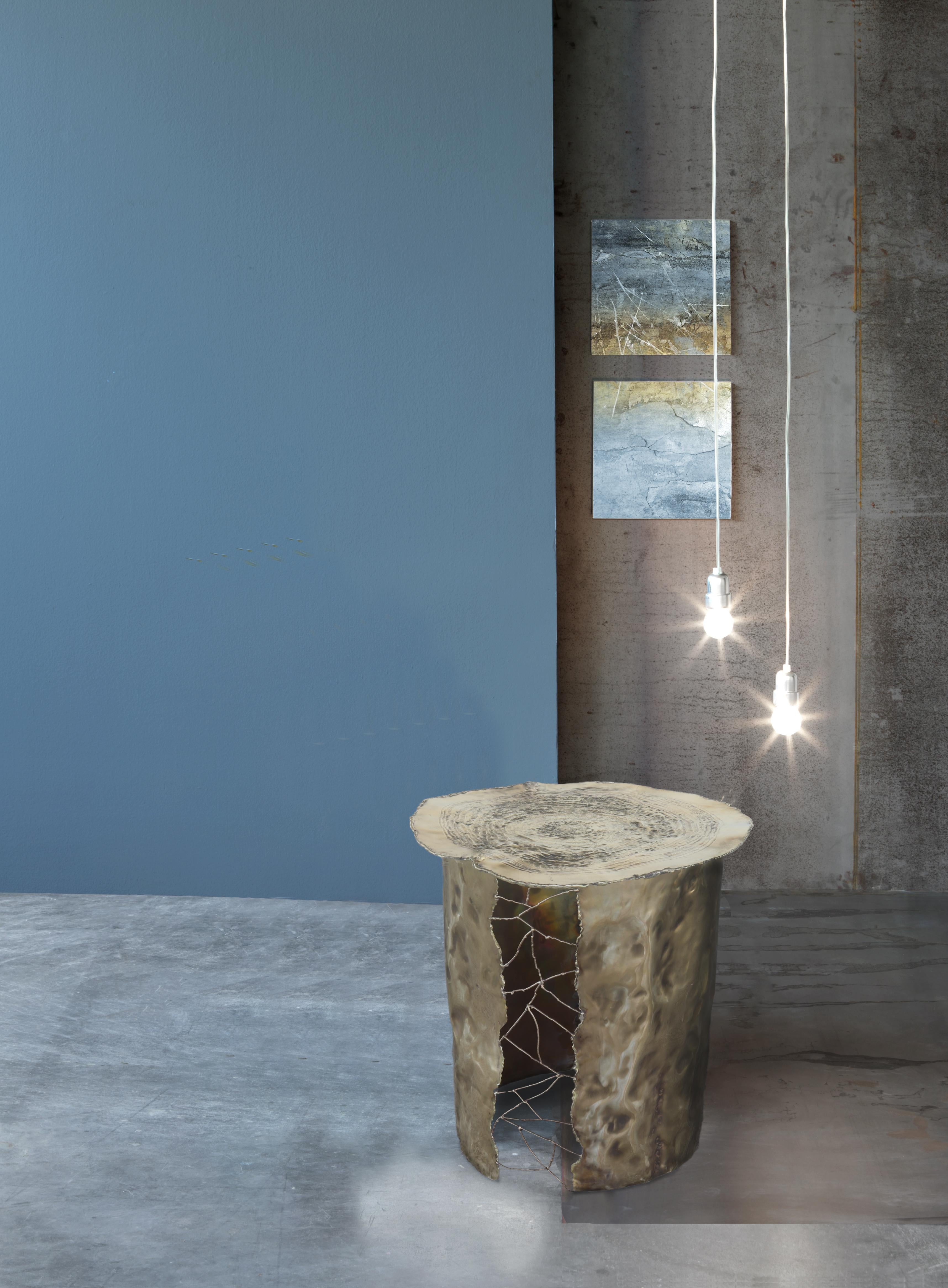 Modern side table realized in hammered brass. The top is in brass worked with fire. Entirely crafted by hands in Italy, signed and numbered.
The power of fire, the connections between the elements, new and ancient techniques contribute to the