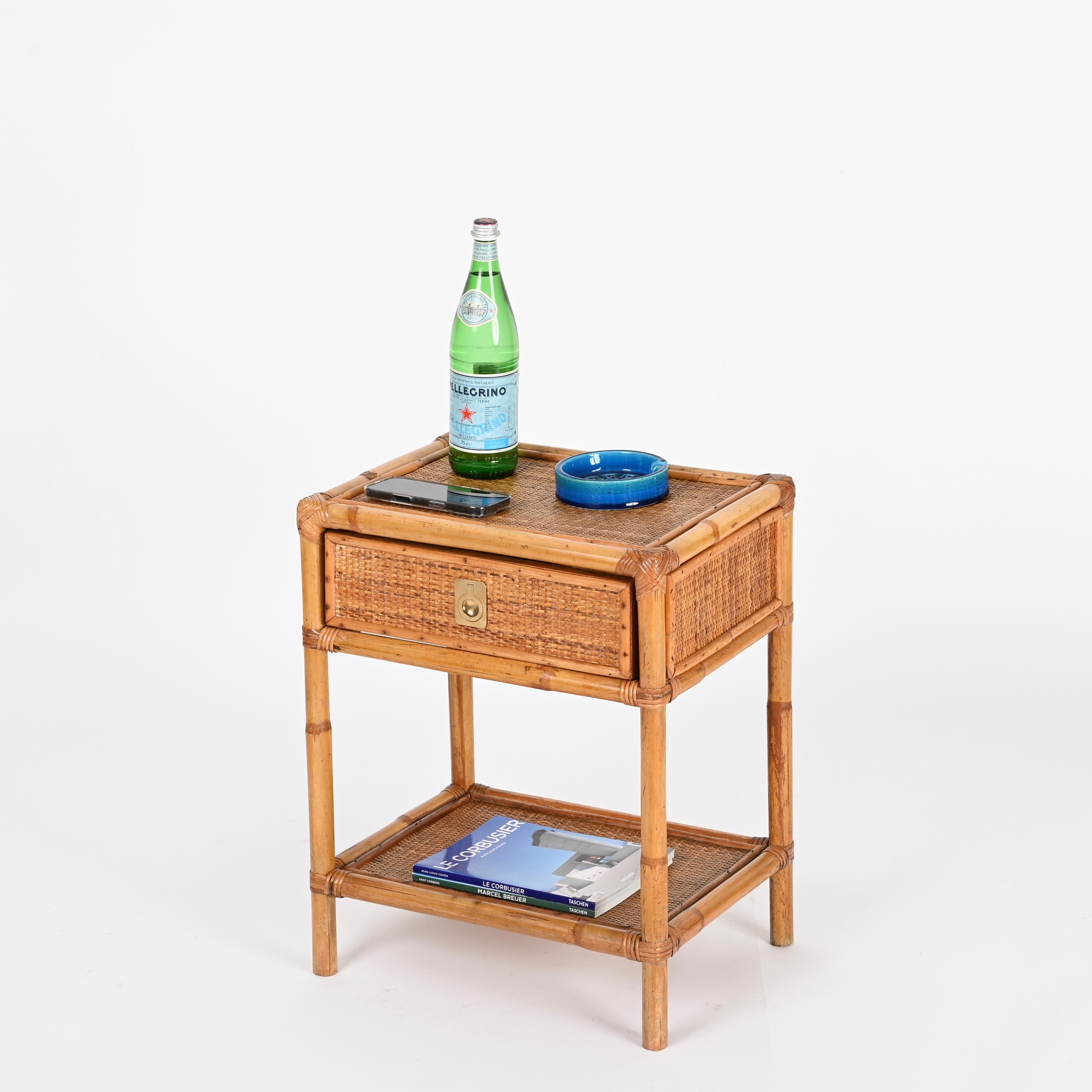 Stunning Mid-Century nightstand or side table in bamboo, woven wicker and brass. This charming organic bedside table was designed by Dal Vera and produced in Italy during the 1960s.

This stylish French Riviera style table is in amazing condition