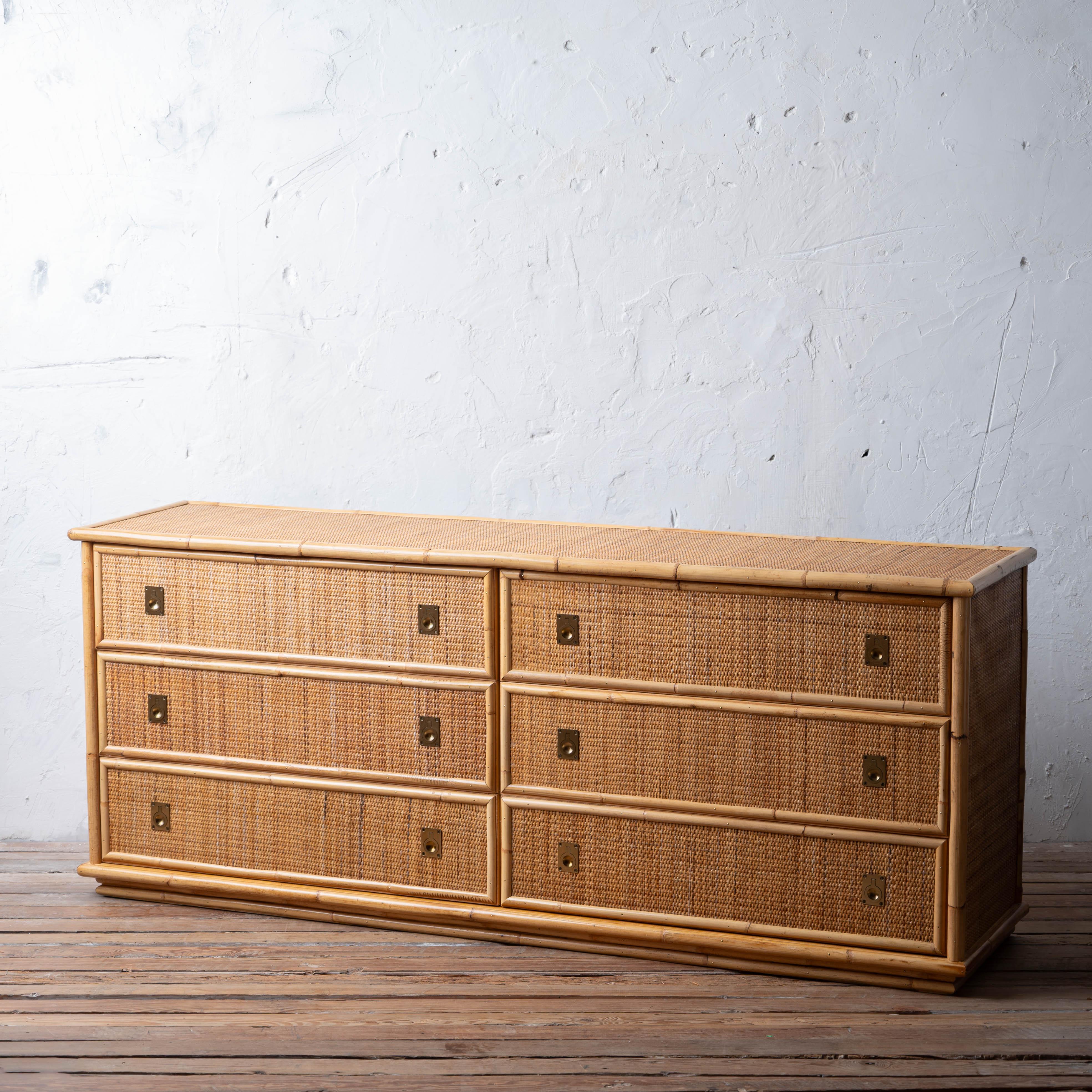 A six drawer campaign style woven rattan dresser by Dal Vera, 1970s.

72 inches wide by 18 ½ inches deep by 30 inches tall


