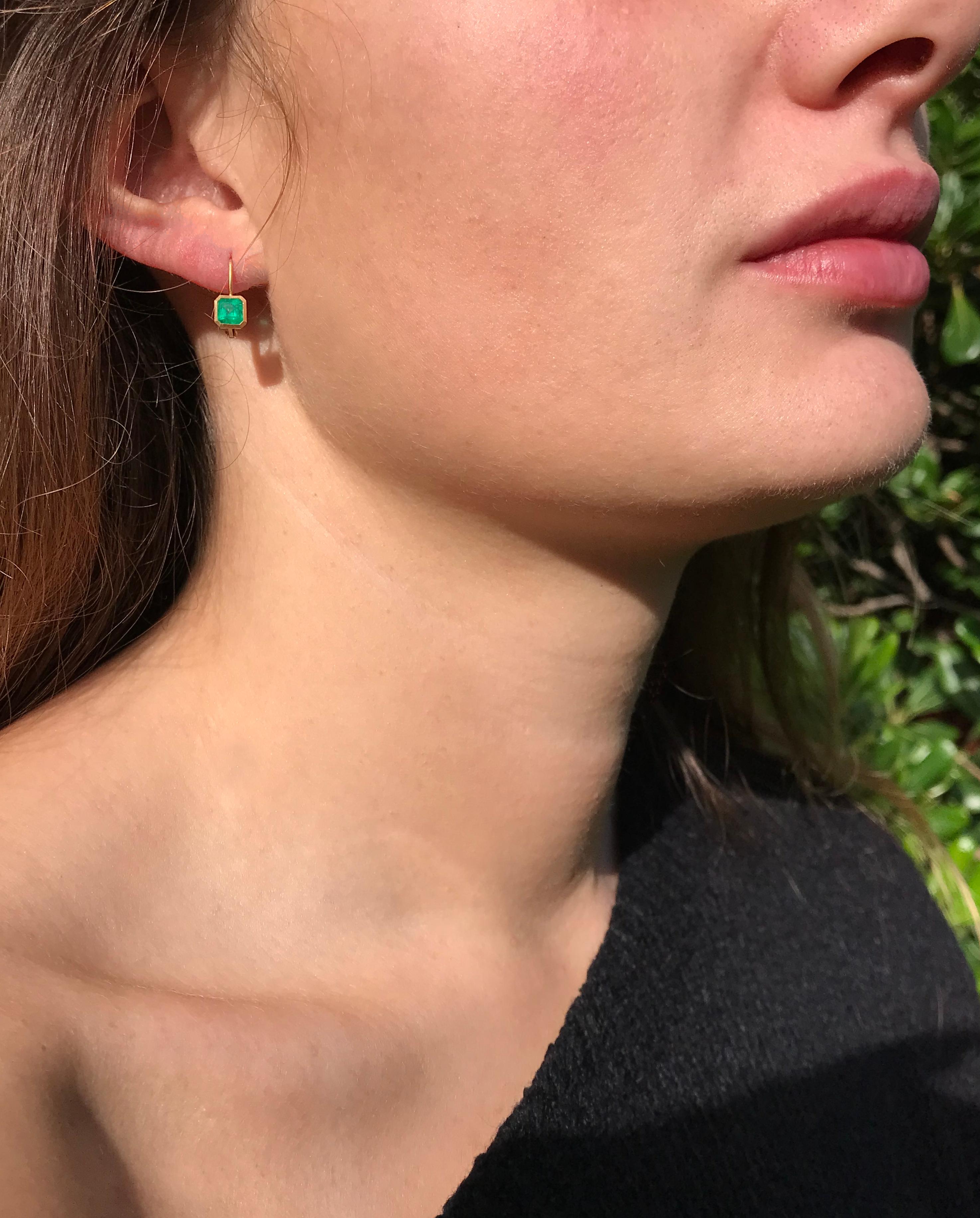 Dalben design  18k yellow gold matte finishing very small earrings with two bezel-set emerald faceted cut  Colombian emerald weight 0,9 carats . 
Bezel stone dimensions :
5,6 x5,5 mm 
height with leverback 14 mm
The earrings has been designed and