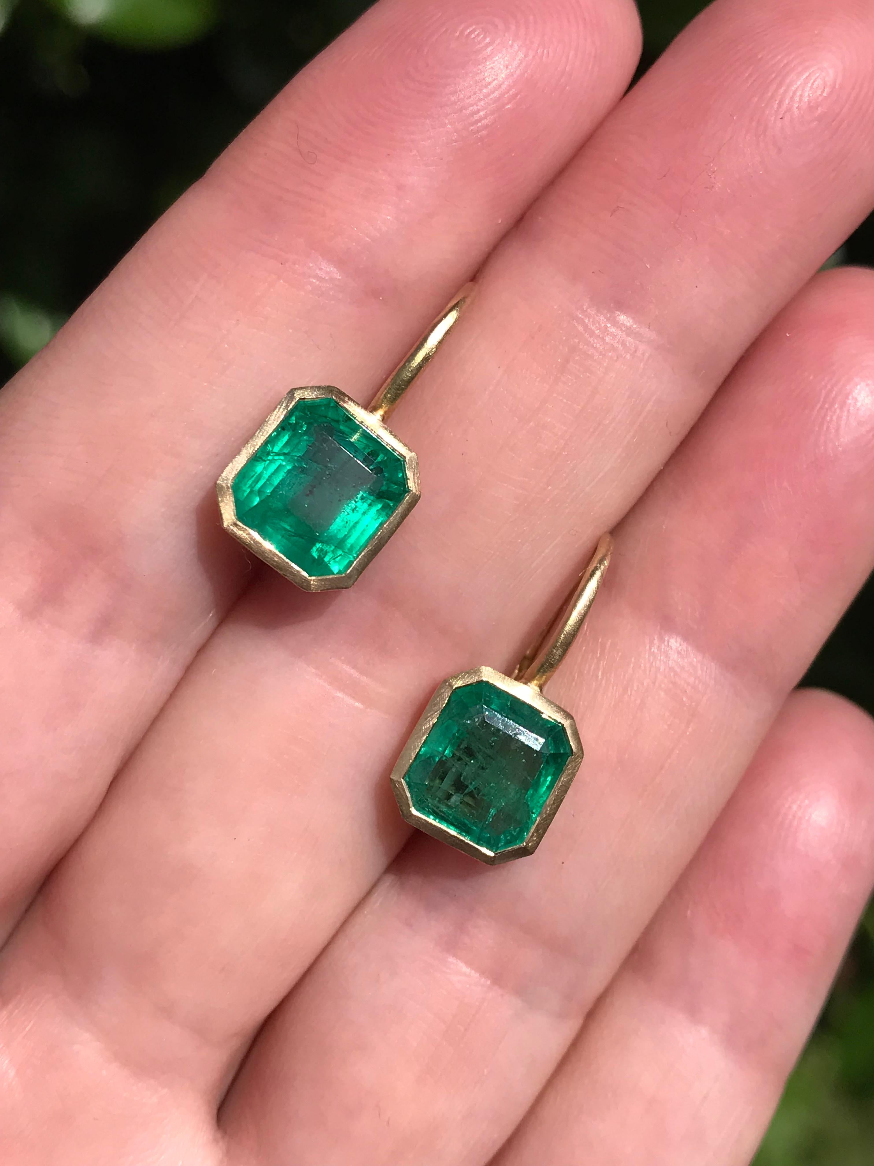 Dalben design  18k yellow gold matte finishing earrings with two bezel-set emerald faceted cut  Zambian emerald weight 4,42 carats .
They are not a perfect pair ,  
Bezel stone dimensions :
9,6 x 9 mm   9,7 x 9,1 mm
height with leverback 19,2 mm
The