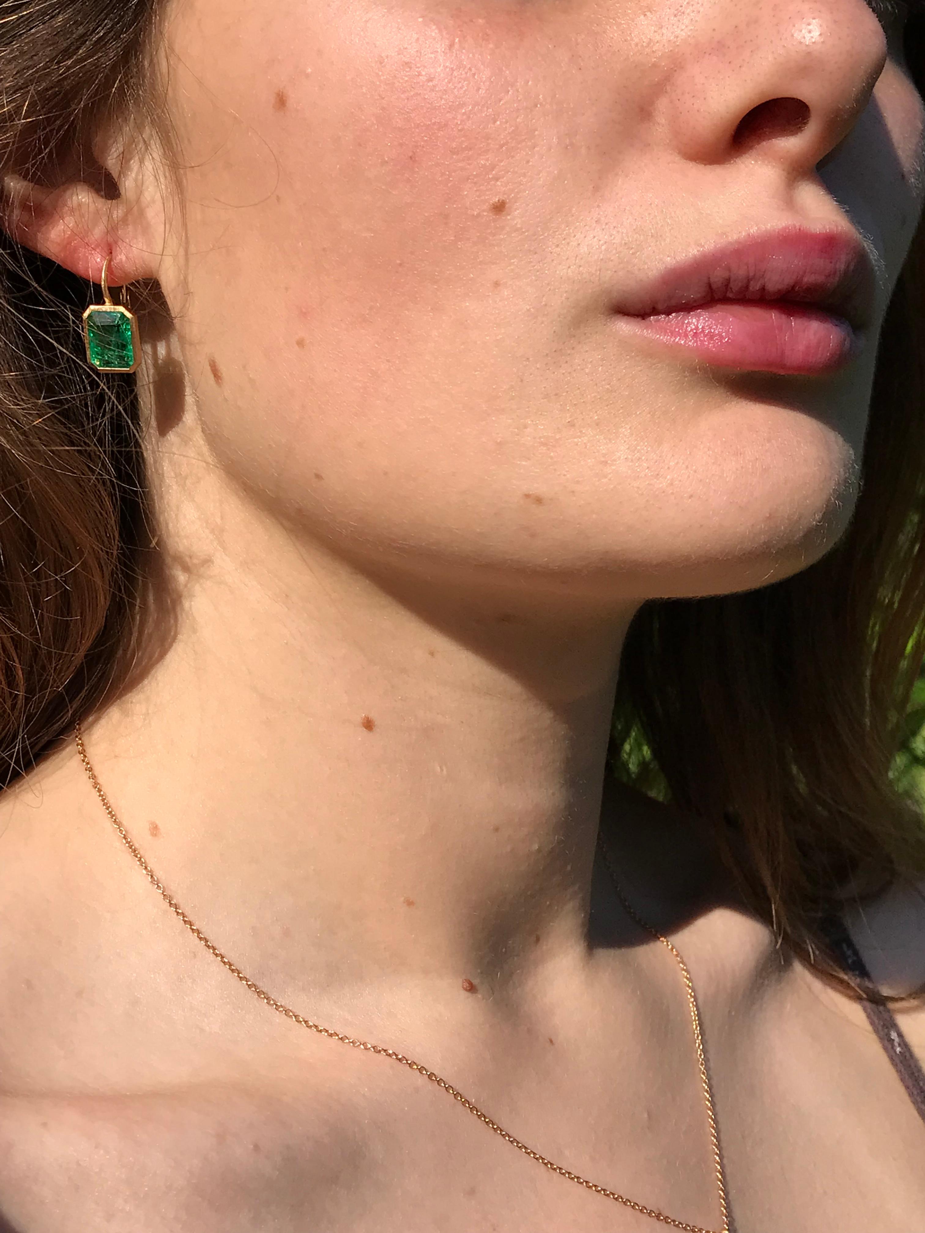 Dalben design  18k yellow gold matte finishing earrings with two bezel-set emerald faceted cut  Zambian emerald total weight 6,94 carats .
They are not a perfect pair ,  
Bezel stone dimensions :
11,7 x 9,3 mm   11,7 x 8,9 mm
height with leverback