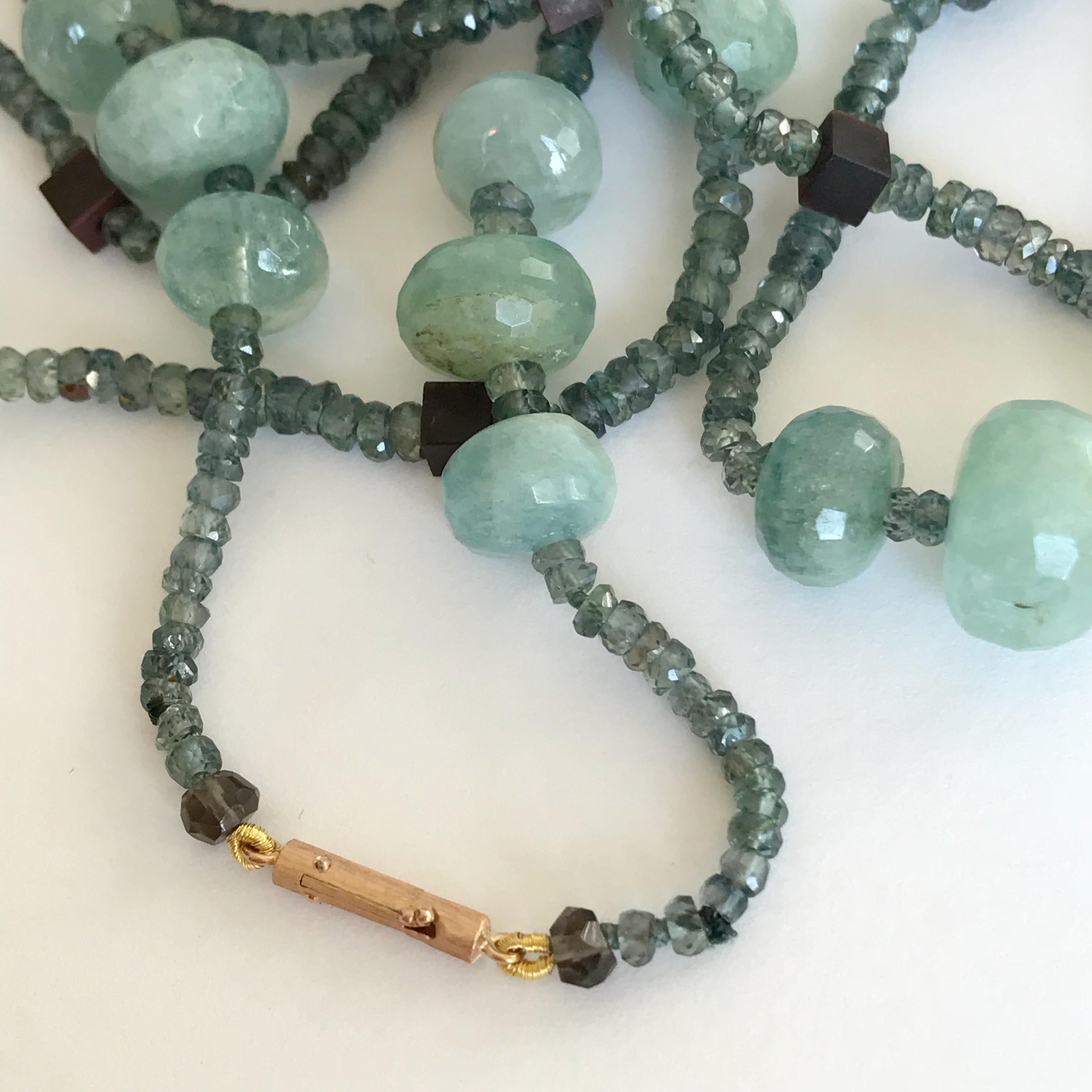 Dalben design long necklace composed of aquamarine big bead , green-grey sapphire faceted bead , iron stone cubic bead and a 18 k rose gold millerighe hand engraved closure. 
The necklace length is 40 inch ( 102 cm ).
Beads dimension : aquamarine