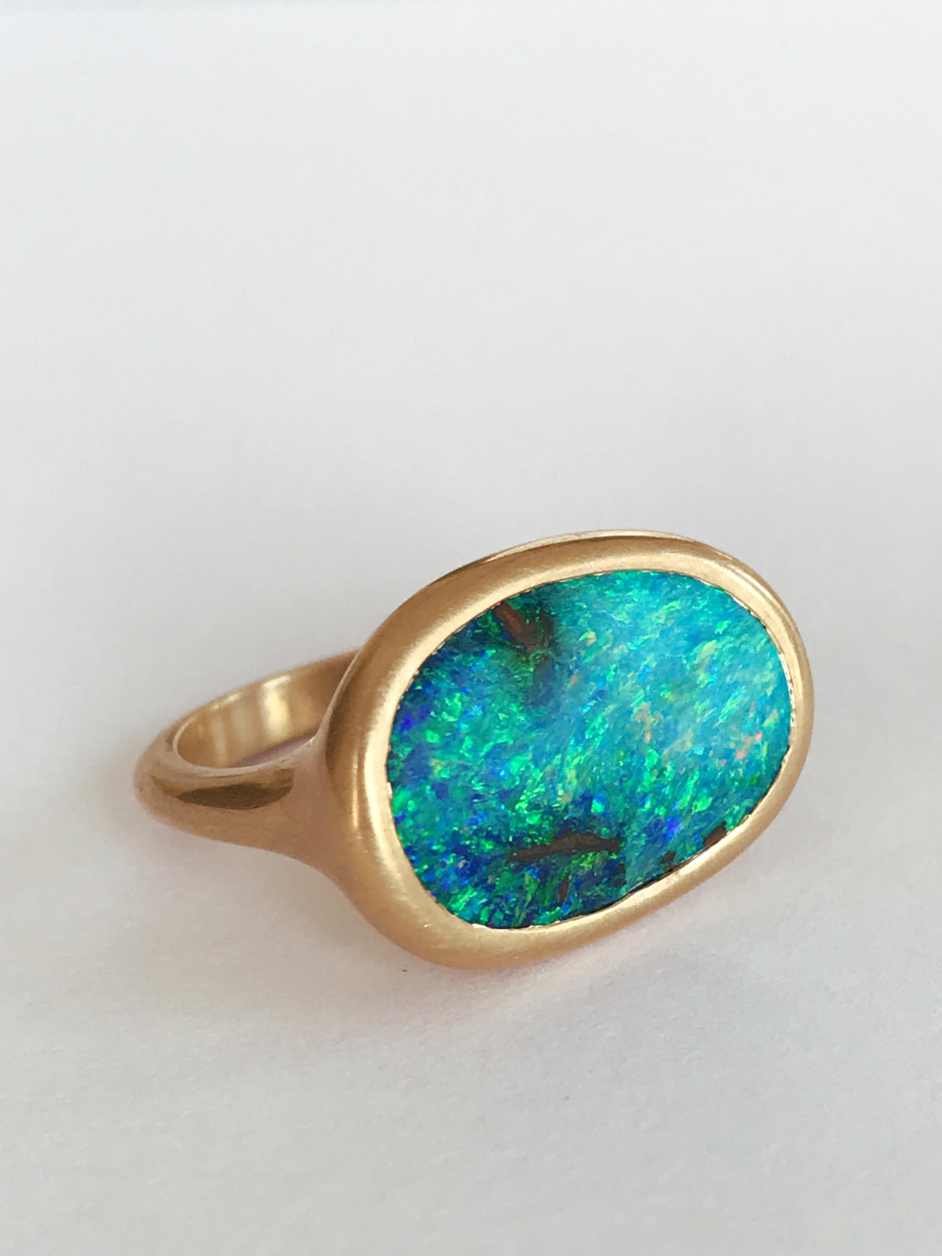 Dalben design One of a kind 18 kt yellow gold matte finishing ring with a 5,95 carat bezel-set wonderful Australian Boulder Opal .  
The stone sea bed colors  are azure - green with little deep light spots.
The oval shape have a soft curve surface