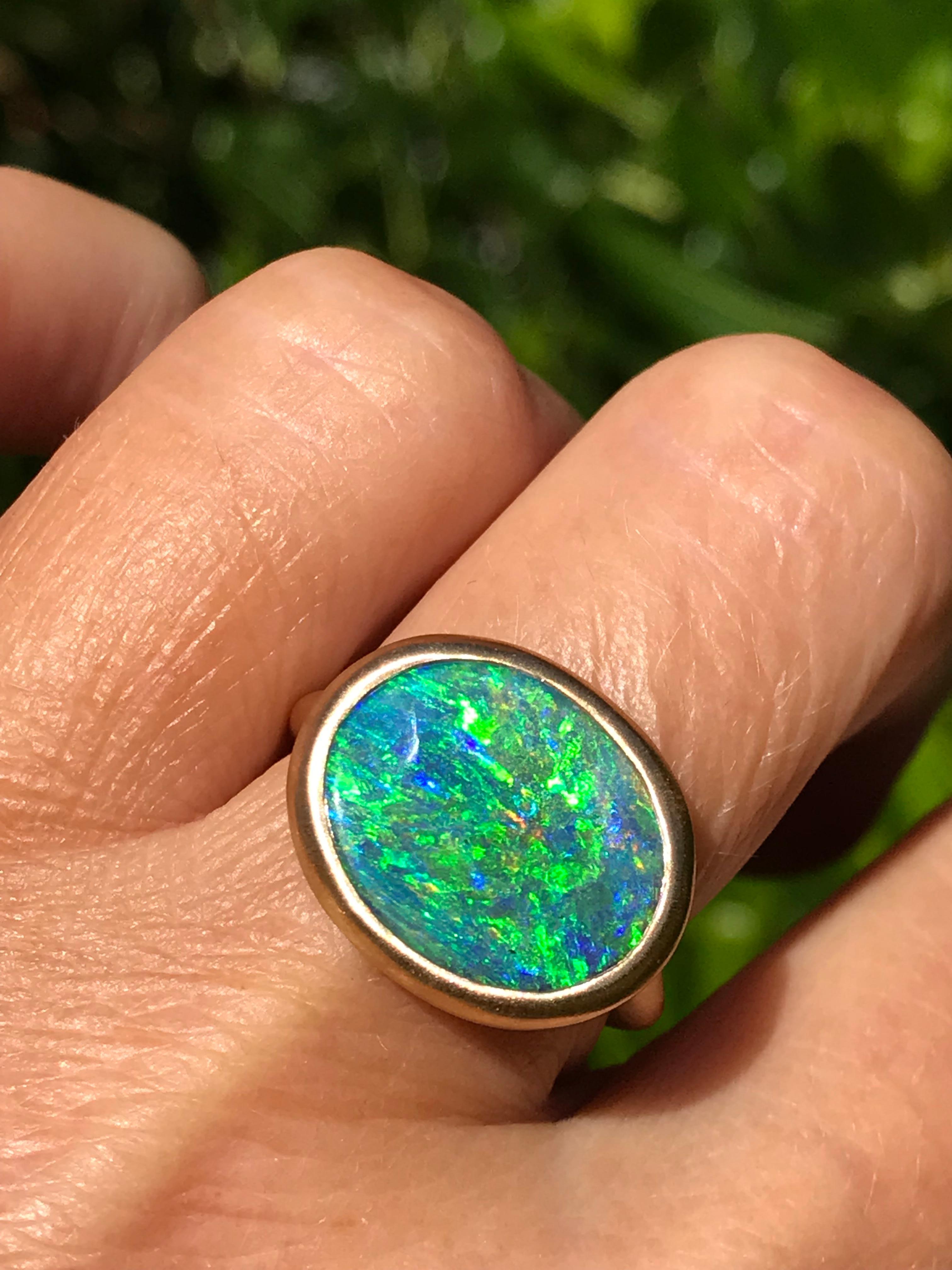 Dalben design 18k yellow gold satin finishing ring with a  7,4 carat bezel-set oval shape magnificent Queensland mine Australian boulder opal . 
The Australian Boulder Opal have deep blue and green spots.
Ring size US  7 1/4 - EU 55 re-sizable to