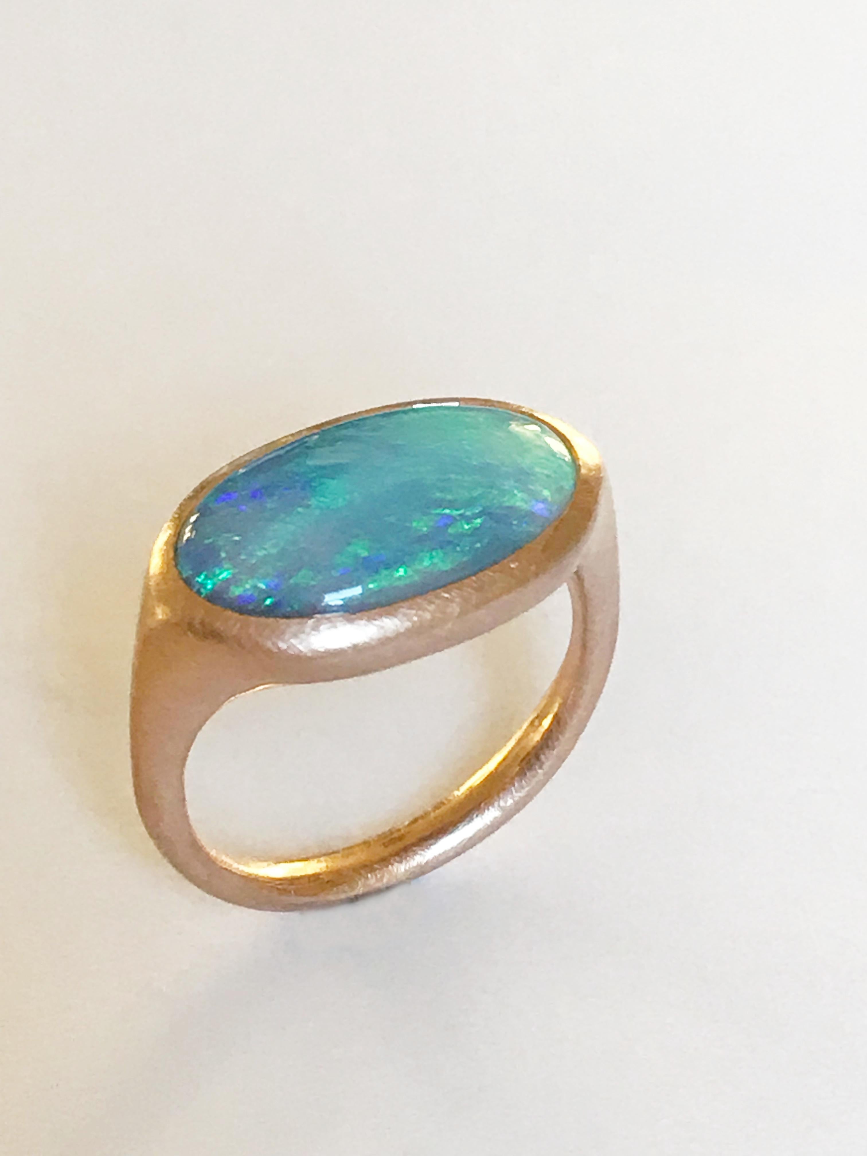 Dalben design One of a kind 18 kt rose gold matte finishing ring with a 3,78 carat bezel-set  oval Lightning Ridge Australian Opal  .  
The stone has light blue green pastel colors .
Ring size 7 1/4 - EU 55 re-sizable to most finger sizes.  
Bezel