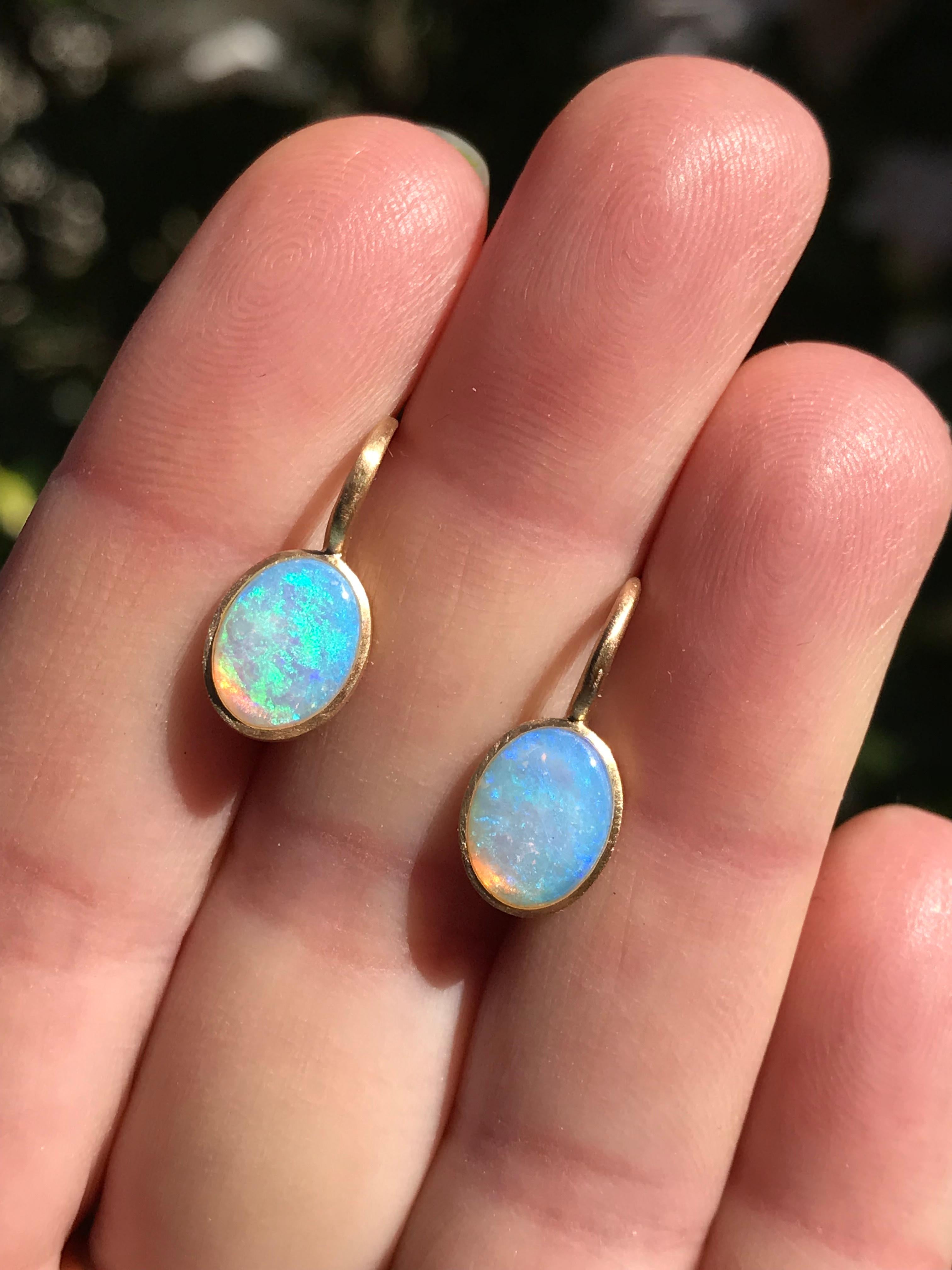 Dalben design  18k yellow gold matte finishing small earrings with two bezel-set oval cabochon blue Australian solid opals weight 1,6 carats . 
Bezel stone dimensions :
width 8 mm
height without leverback 10 mm
height with leverback 18 mm
The