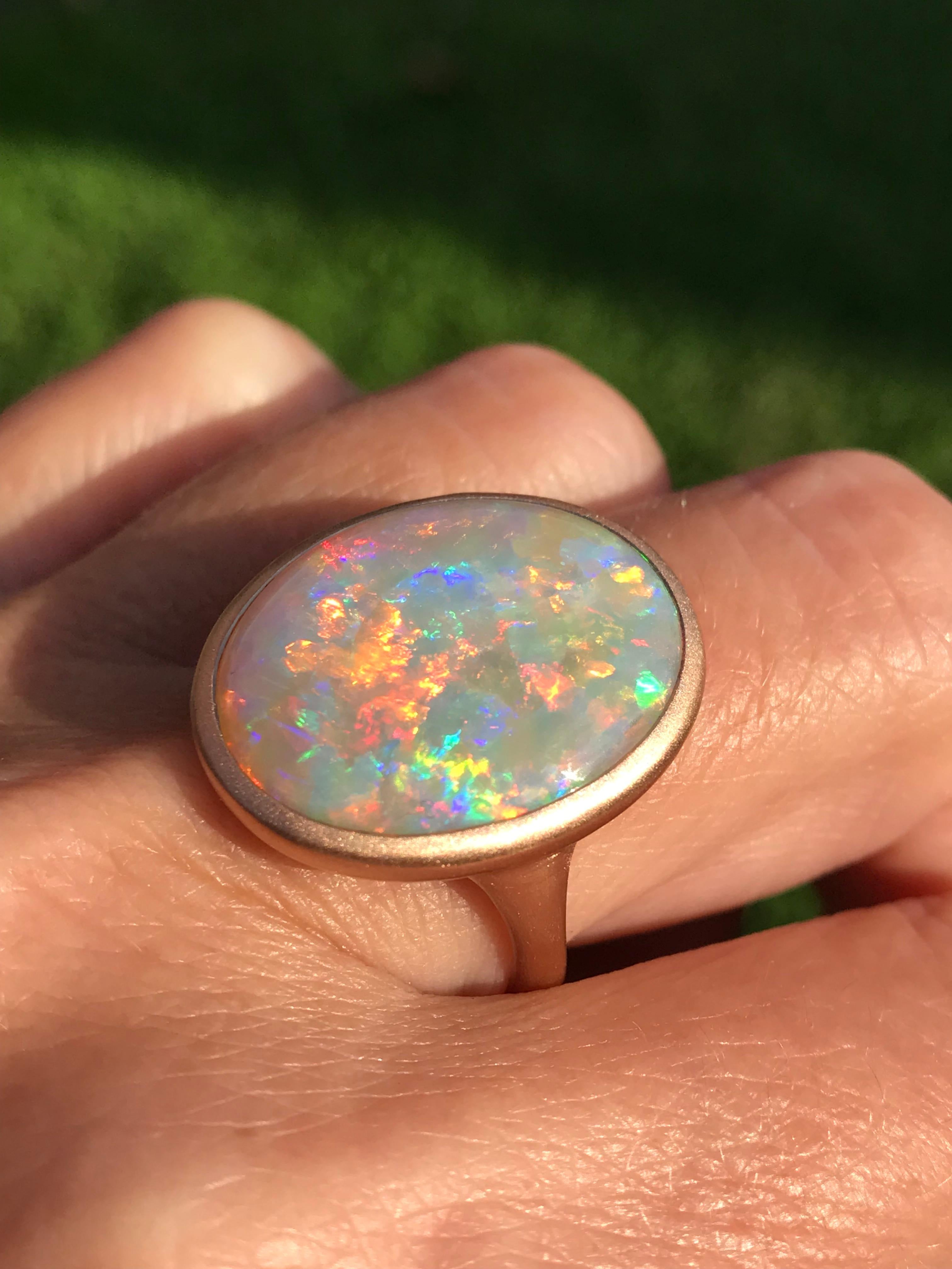 Dalben design 18k rose gold satin finishing ring with a  10,35 carat bezel-set oval shape magnificent Coober Pedy Australian crystal opal . 
This wonderful Australian Opal have a kaleidoscope of dazzling colors.
Ring size US  7 1/2 - EU 55