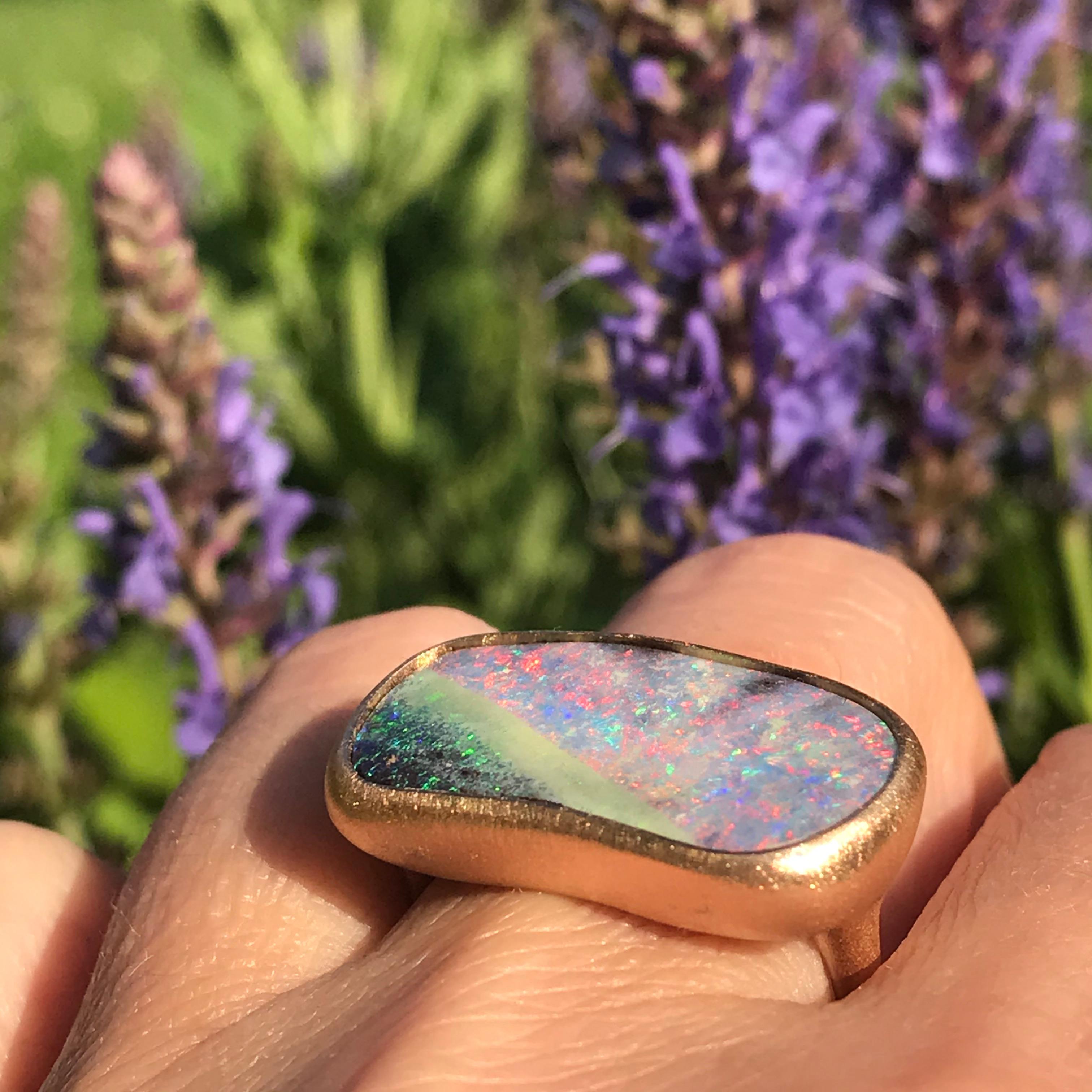 Dalben design 18k rose gold satin finishing ring with a  13,7 carat bezel-set pink green Australian Boulder Opal .
The stone has pink spots on pastel colors with a deep green spots corner and reminds a magical abstract landscape.
Ring size 7 1/4 -