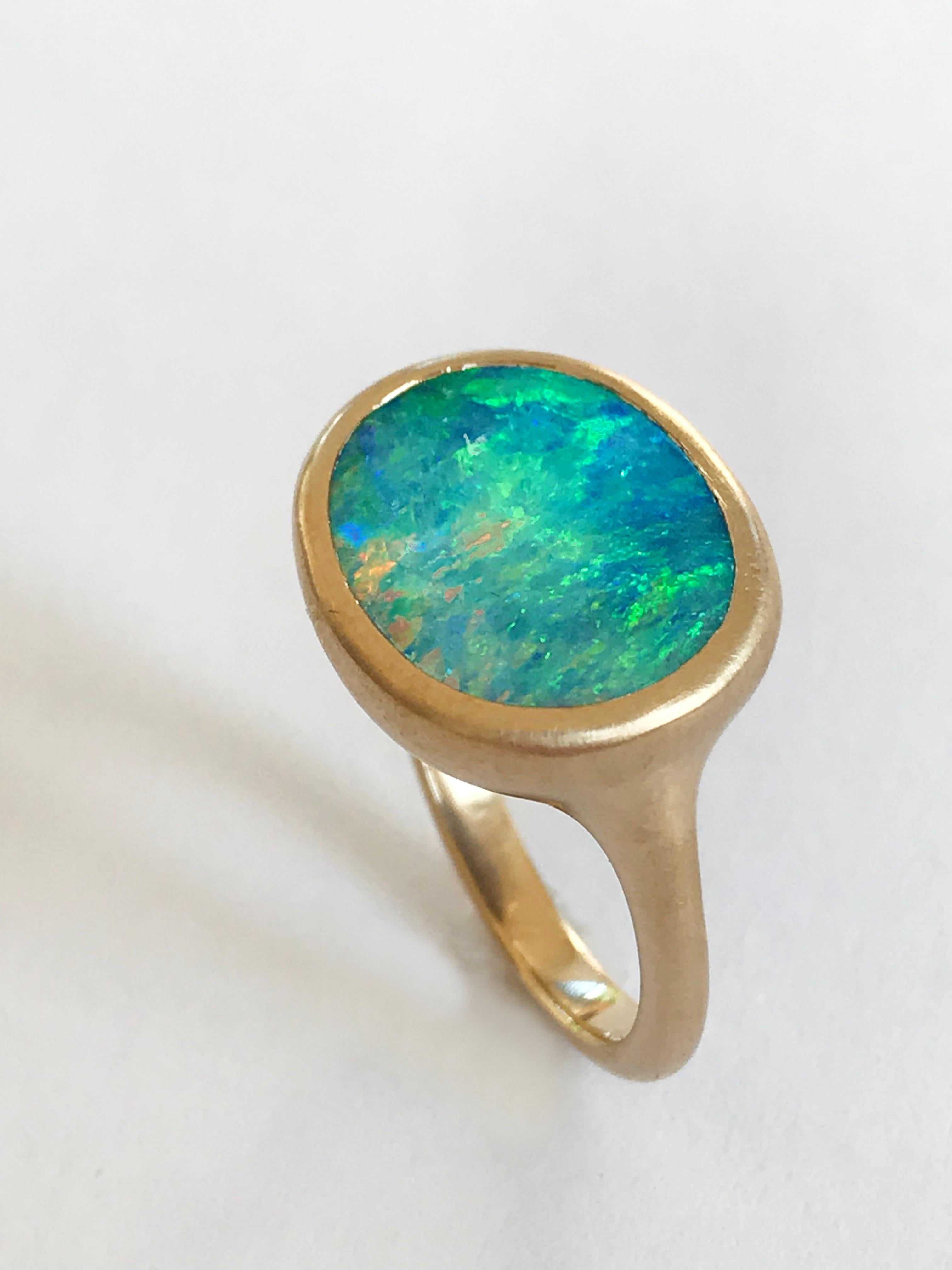 Dalben design One of a kind 18 kt yellow gold matte finishing ring with a 5,4 carat oval shape bezel-set wonderful light blue Australian Boulder Opal.  
The stone sea bed colors  are azure - green with  pink green and blue light spots.
Ring size 6