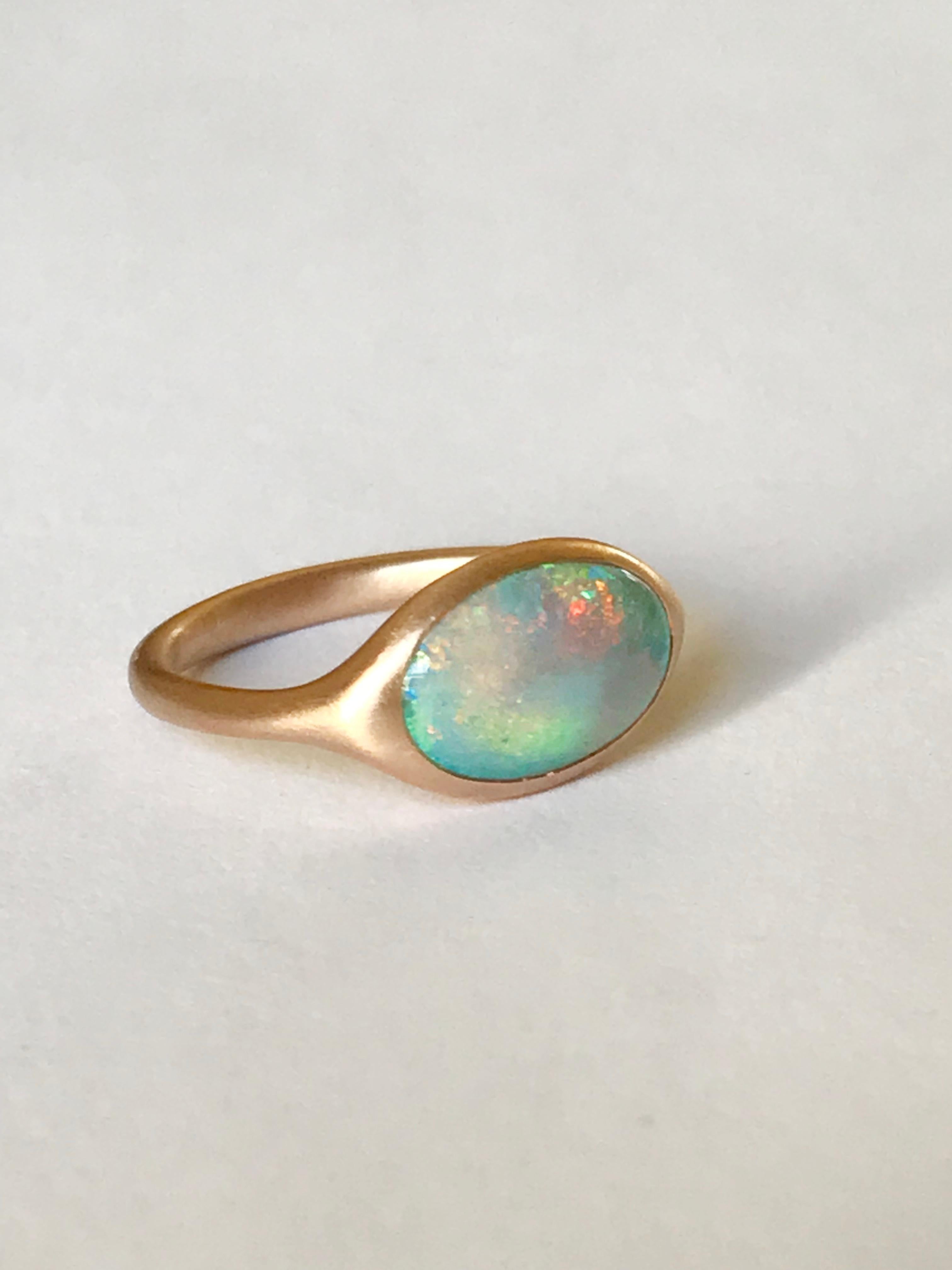 Dalben design 18k rose gold satin finishing ring with a 1,73 carat bezel-set oval shape Australian crystal opal from Lighting Ridge mine . 
Ring size US 6 3/4 - EU 54 re-sizable to most finger sizes. 
Bezel setting dimension: 
width 14 mm, 
height