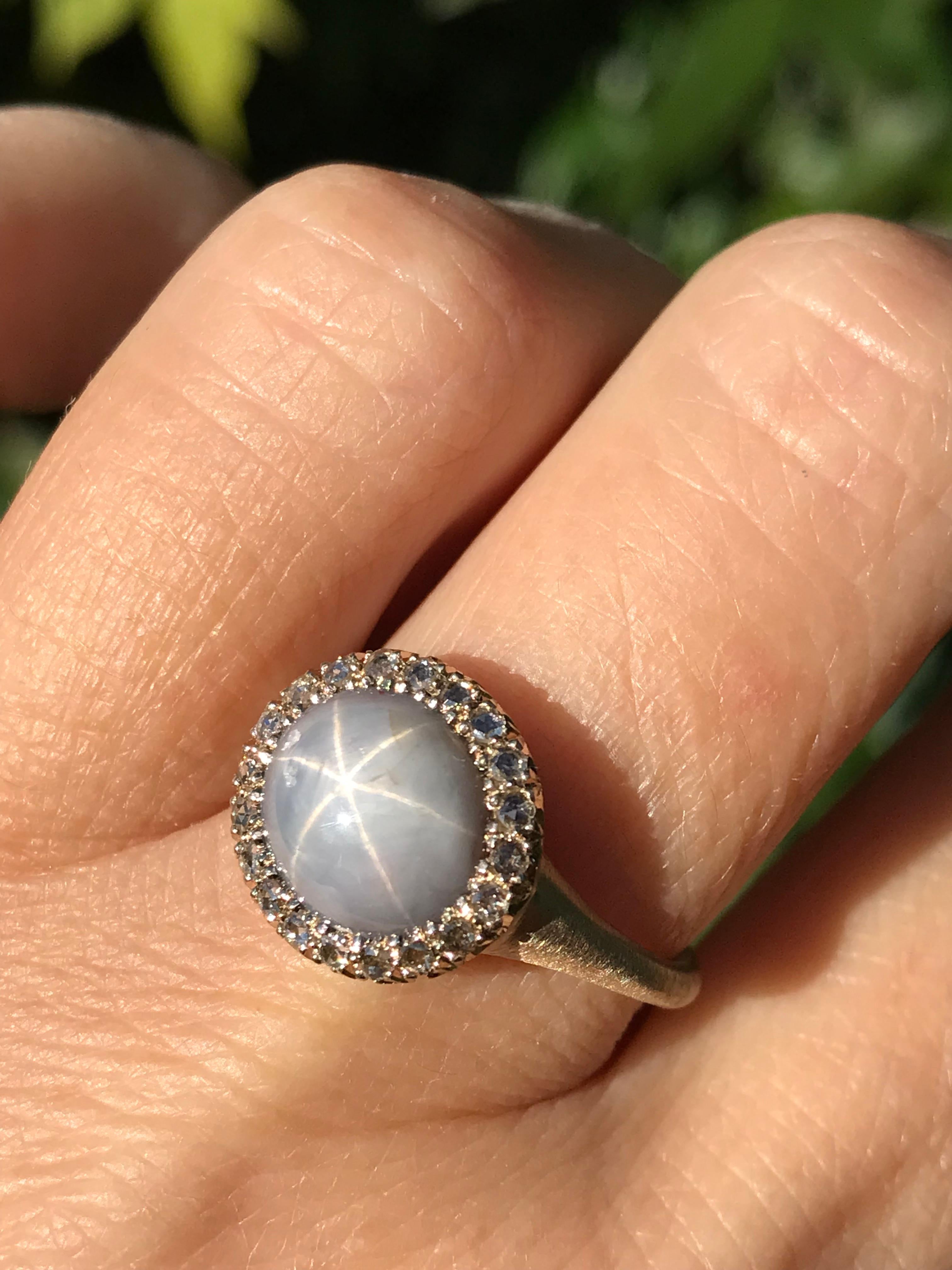 Dalben design  18 kt white gold satin finishing ring with an oval cabochon cut silver star sapphire  weight 7,03 carat and 24 rose cut white diamonds weight 0,18 carats. 
The sapphire star is visible at sunshine or with a spot / direct light , at