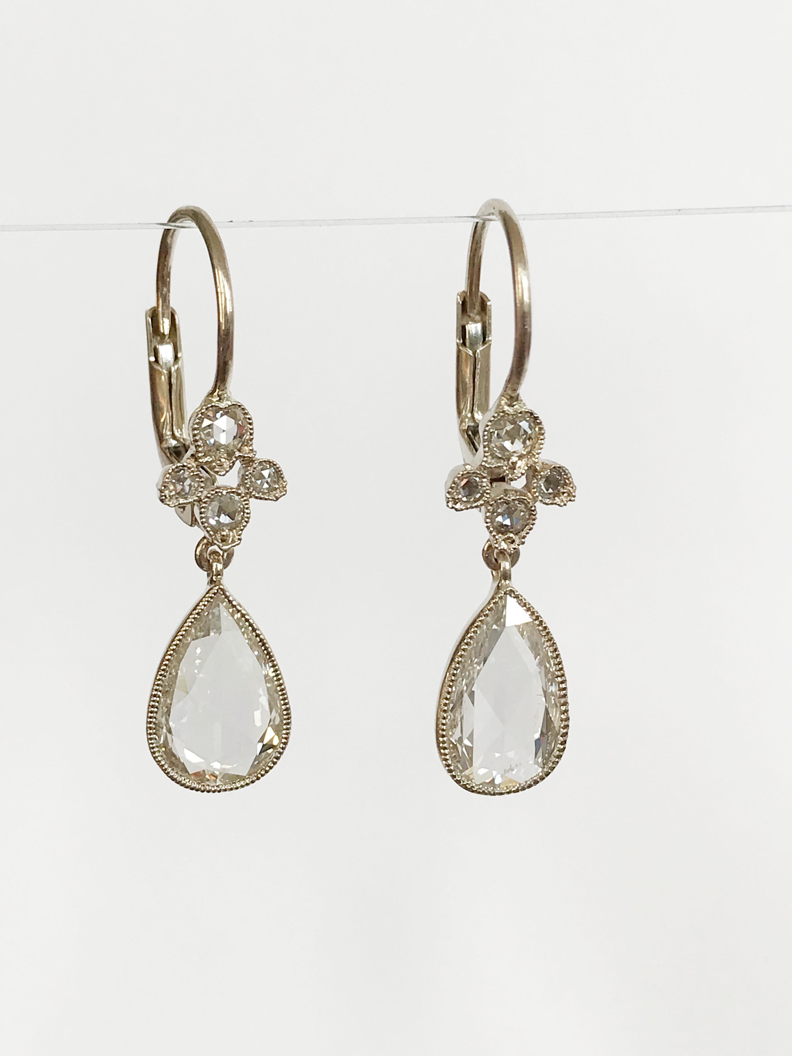 Dalben design One of a Kind 18k white gold earrings with two  bezel-set pear shape rose cut diamonds weigh  1,18 carat and a floral motif  with rose cut diamonds weigh 0,16 carat.
The stone setting is finished with 