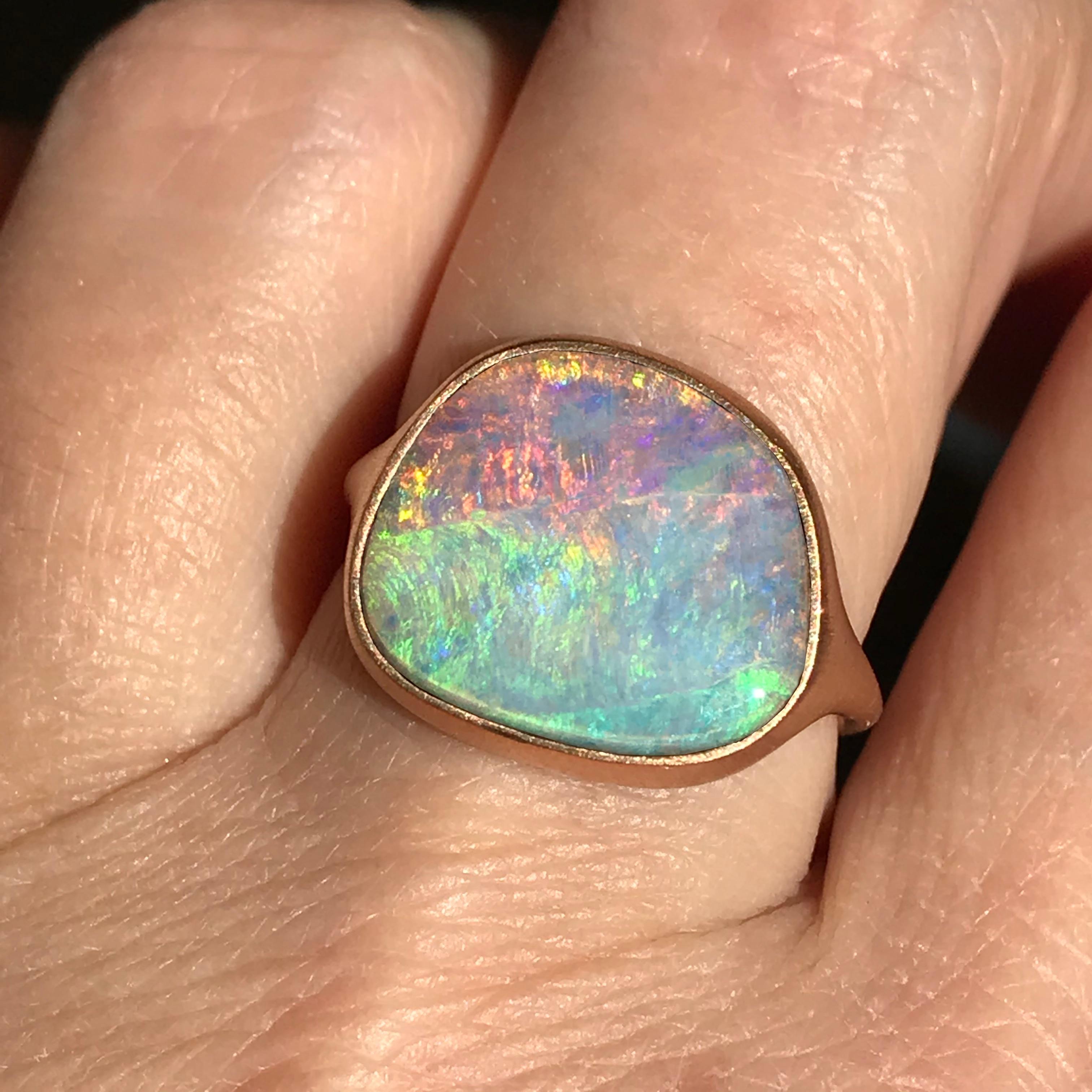Dalben design One of a kind 18k rose gold satin finishing ring with a 6,6 carat bezel-set Australian Boulder Opal .  
The stone rainbow colors continuosly change with the different light from deep blue , to  green , to yellow pink.  
Ring size 6 3/4
