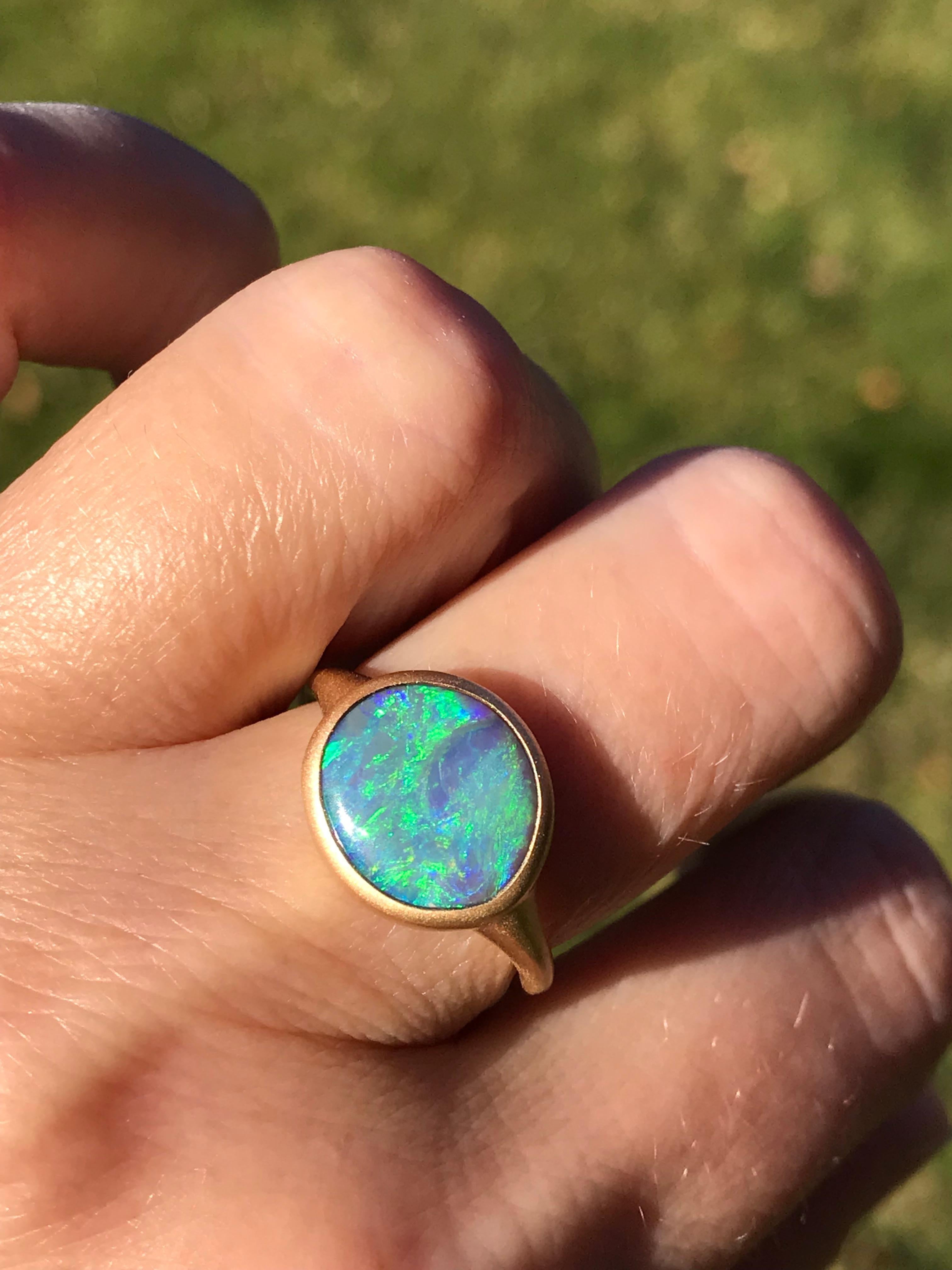 Dalben design 18k yellow gold satin finishing ring with a 3,05 carat bezel-set round-oval shape Australian crystal opal from Lighting Ridge mine .
The opal has wonderful and deep blue green light spots.
Ring size US 6 3/4 - EU 54 re-sizable to most