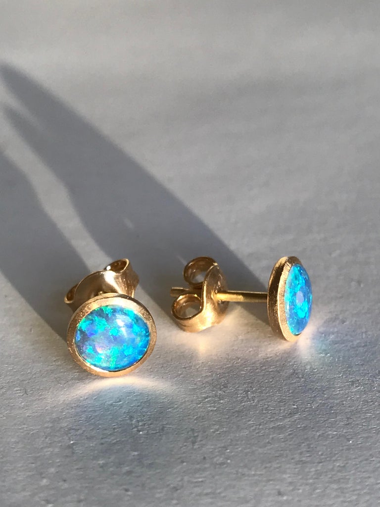 Dalben design  18k yellow gold satin finishing stud earrings with two bezel-set round cabochon blue Australian solid opals weight 0,9 carats . 
Bezel stone dimensions  7 mm .
The earrings has been designed and handcrafted in our atelier in Como