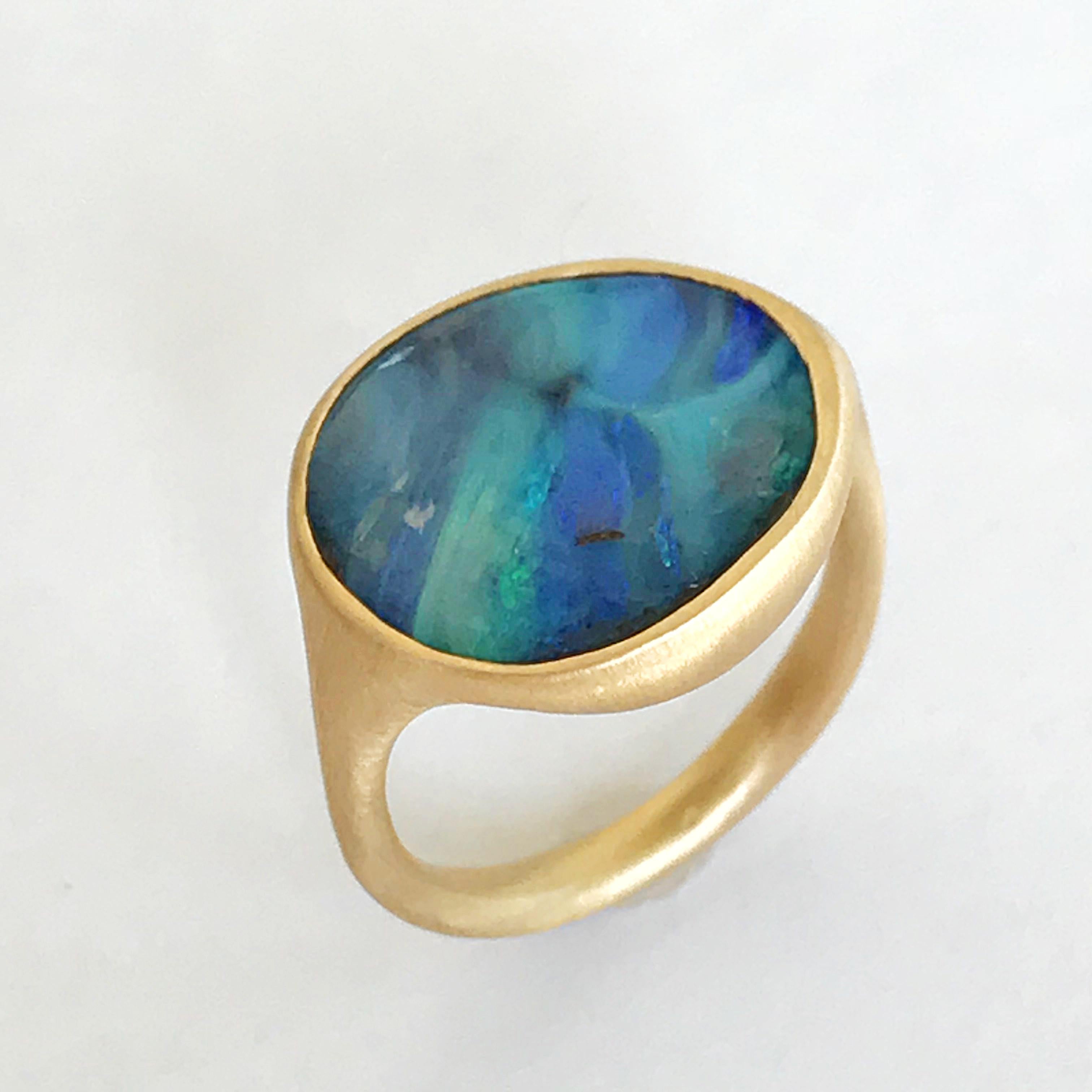 Dalben design One of a kind 18 kt yellow gold ring with a 6,8 carats bezel-set blue stone shape Australian Boulder Opal  .  
Ring size 6  - EU 52 re-sizable .  
Bezel setting dimension:  
max width 17,6 mm,  
max height 15,5 mm. 
The ring has been