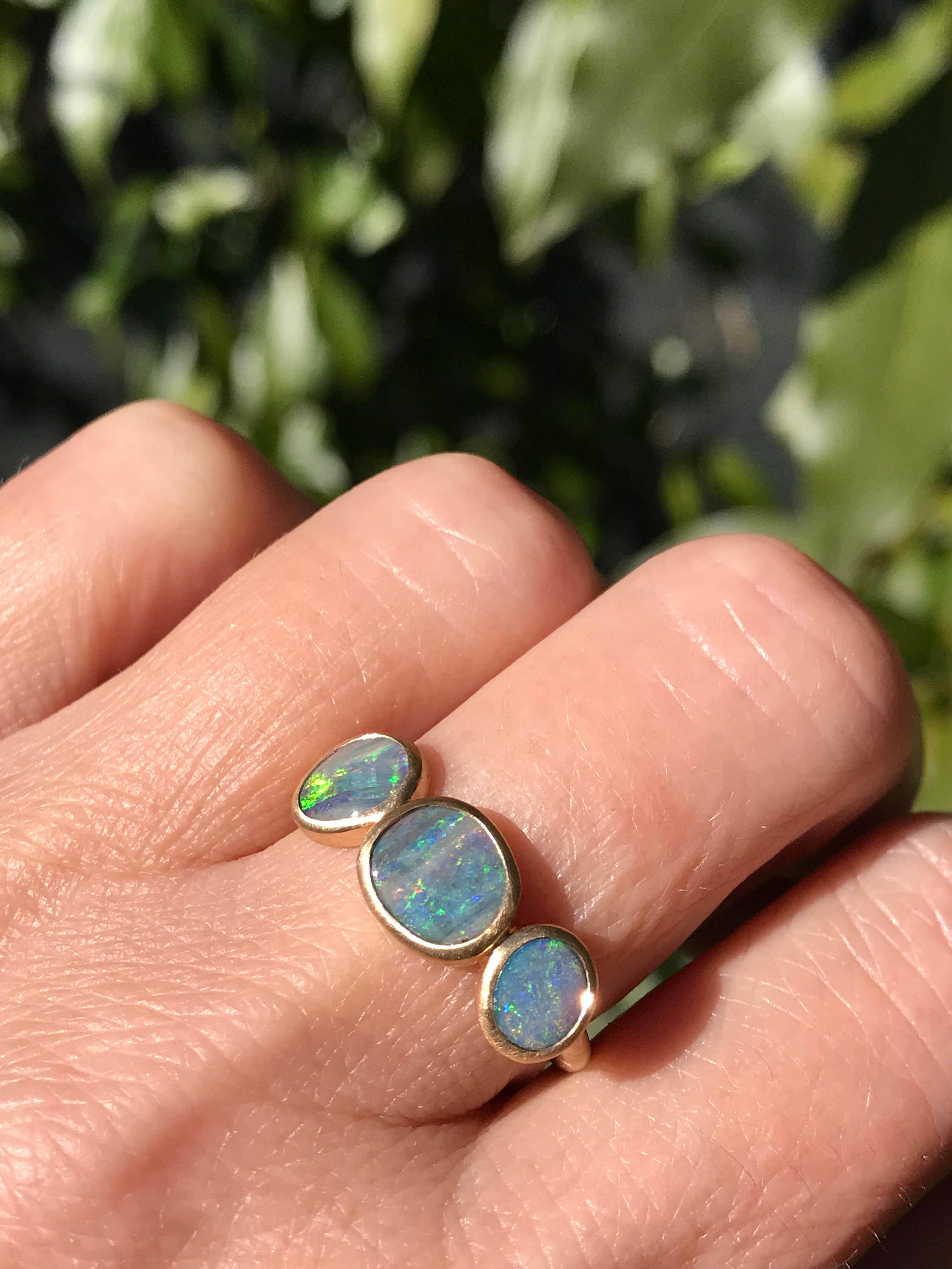 Dalben design One of a kind 18 kt yellow  gold ring with three bezel-set blue-violet-green Australian Boulder Opals weight 2,68 carats  .  
Ring size  US 7 1/4  - EU 55 re-sizable .  
Bezels setting dimension:  
max width 20,2 mm,  
max height 8,9