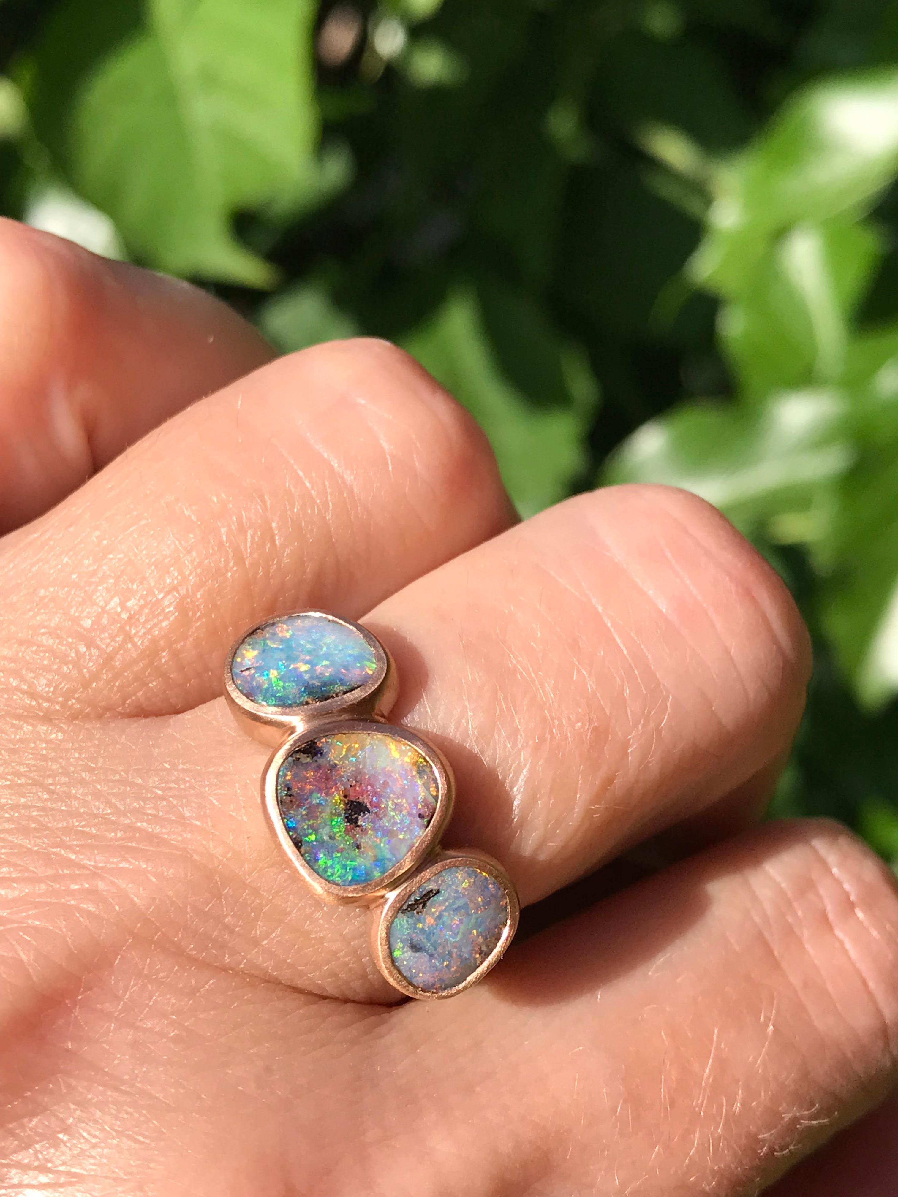 Dalben design One of a kind 18 kt rose  gold ring with three bezel-set blue-green-pink Australian Boulder Opals weight 4,34 carats  .  
Ring size  US 7 1/4  - EU 55 re-sizable .  
Bezels setting dimension:  
max width 23 mm,  
max height 10, mm.